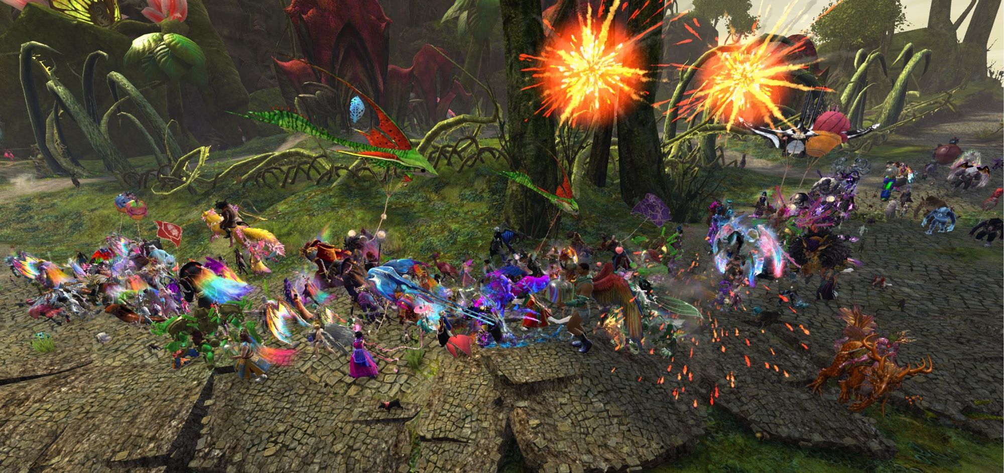 A Guild Wars 2 screenshot of the Tyria Pride March trekking through Caledon Forest. Even more fireworks are going off now.