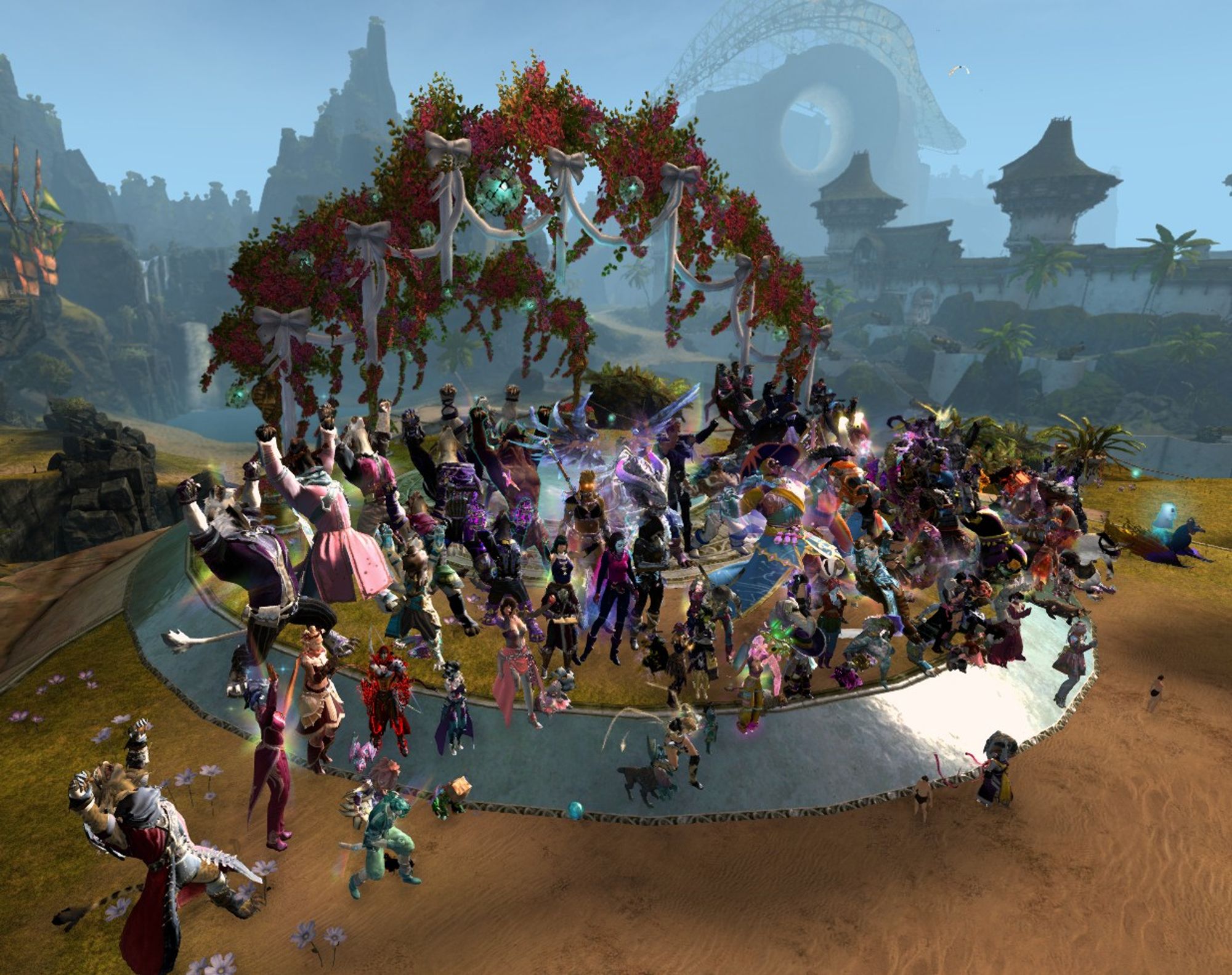 A Guild Wars 2 screenshot of the Tyria Pride Marchers cheering at the Deverol Gardens wedding area in Lion's Arch