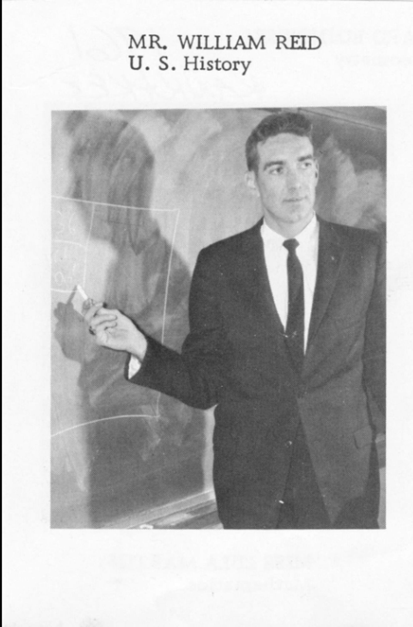 A black-and-white yearbook photo of a man in a dark suit and tie standing at a blackboard. The caption reads Mr. William Reid U.S. History.