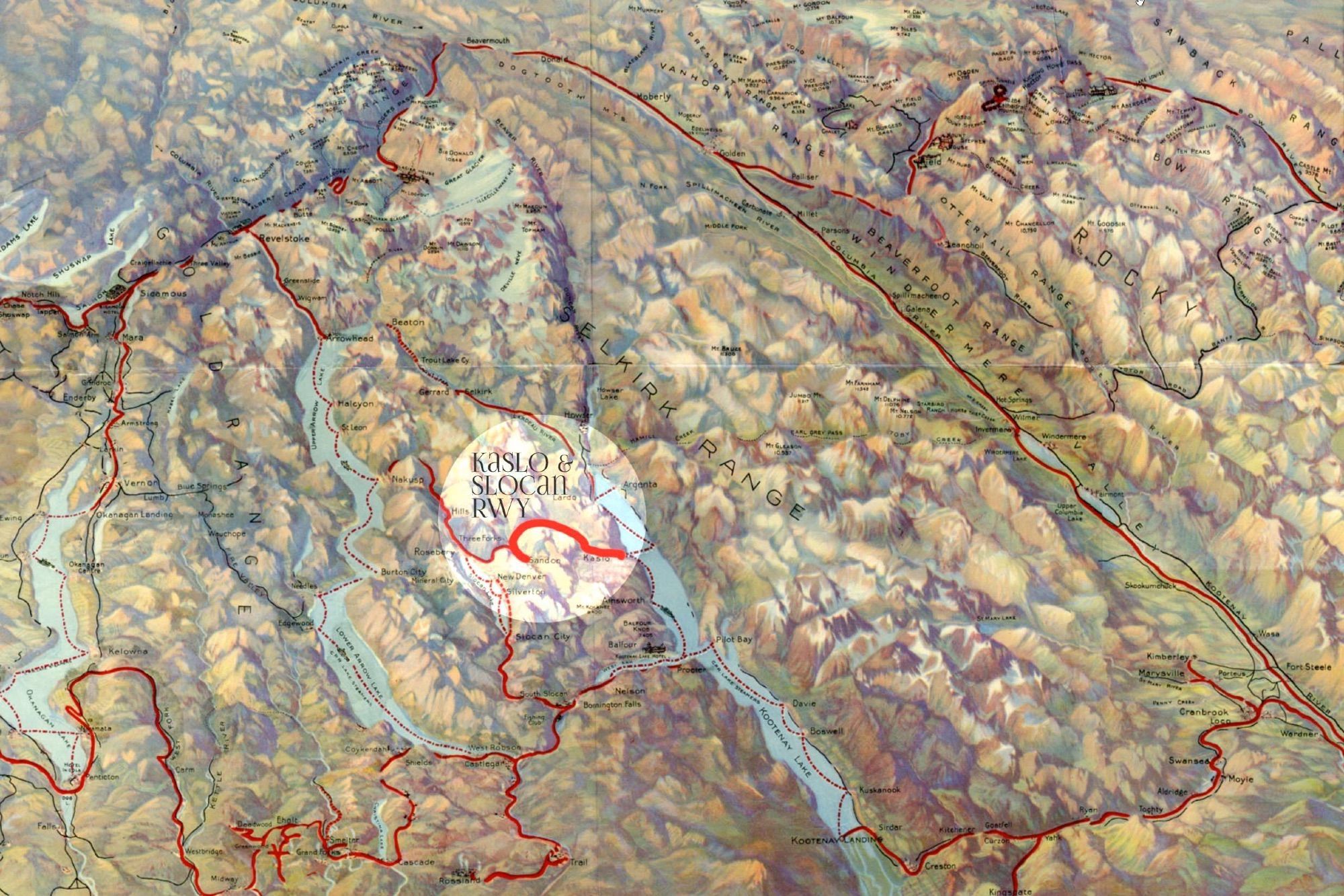 A Victorian satellite produced this 1895 hand-drawn and tinted view of the Kootenays of British Columbia, carefully highlighting the location of the narrow gauge Kaslo & Slocan Railway west of Kootenay Lake.