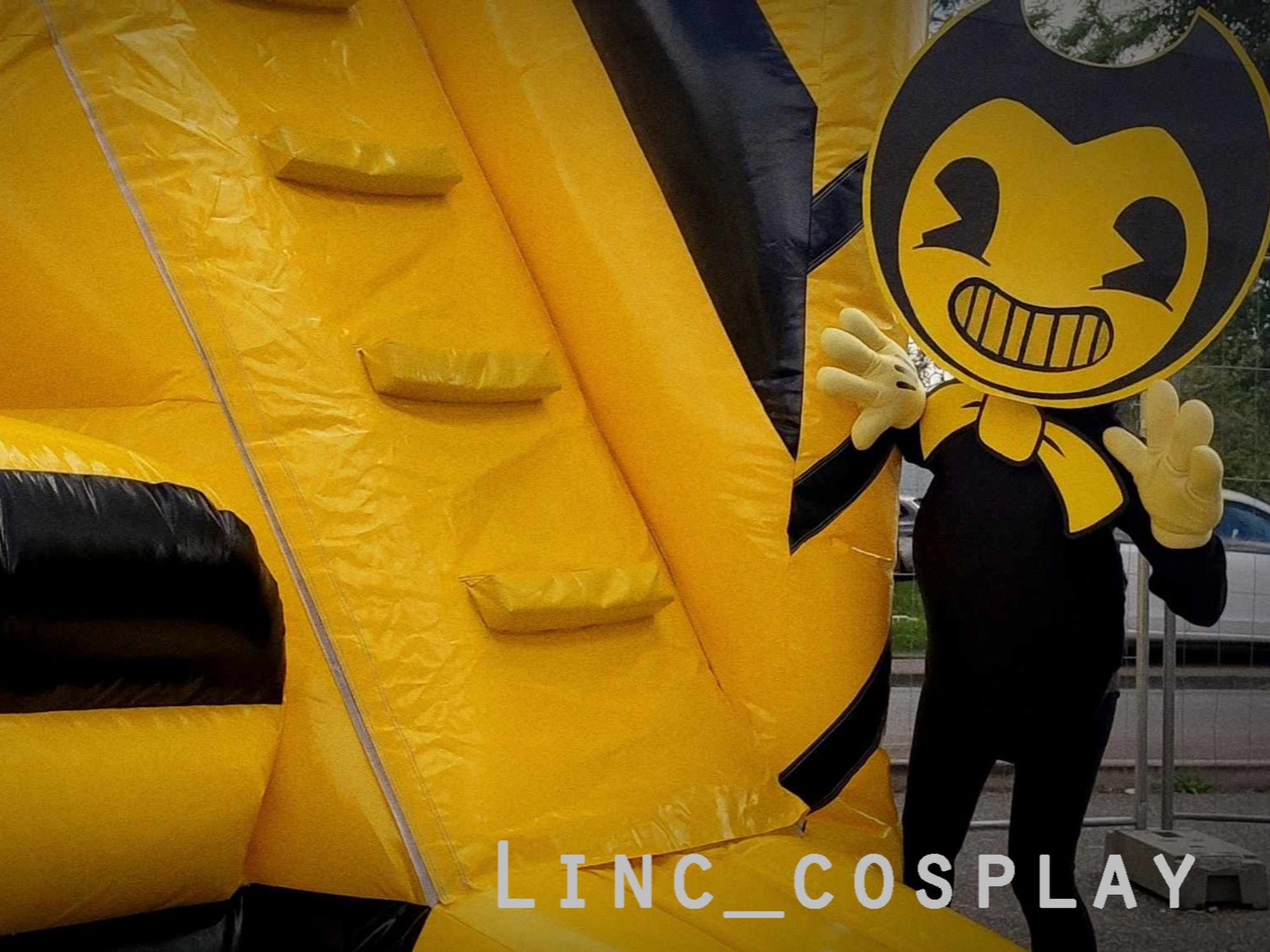 Bendy cosplay who does peek-a-boo at a inflatable castle.