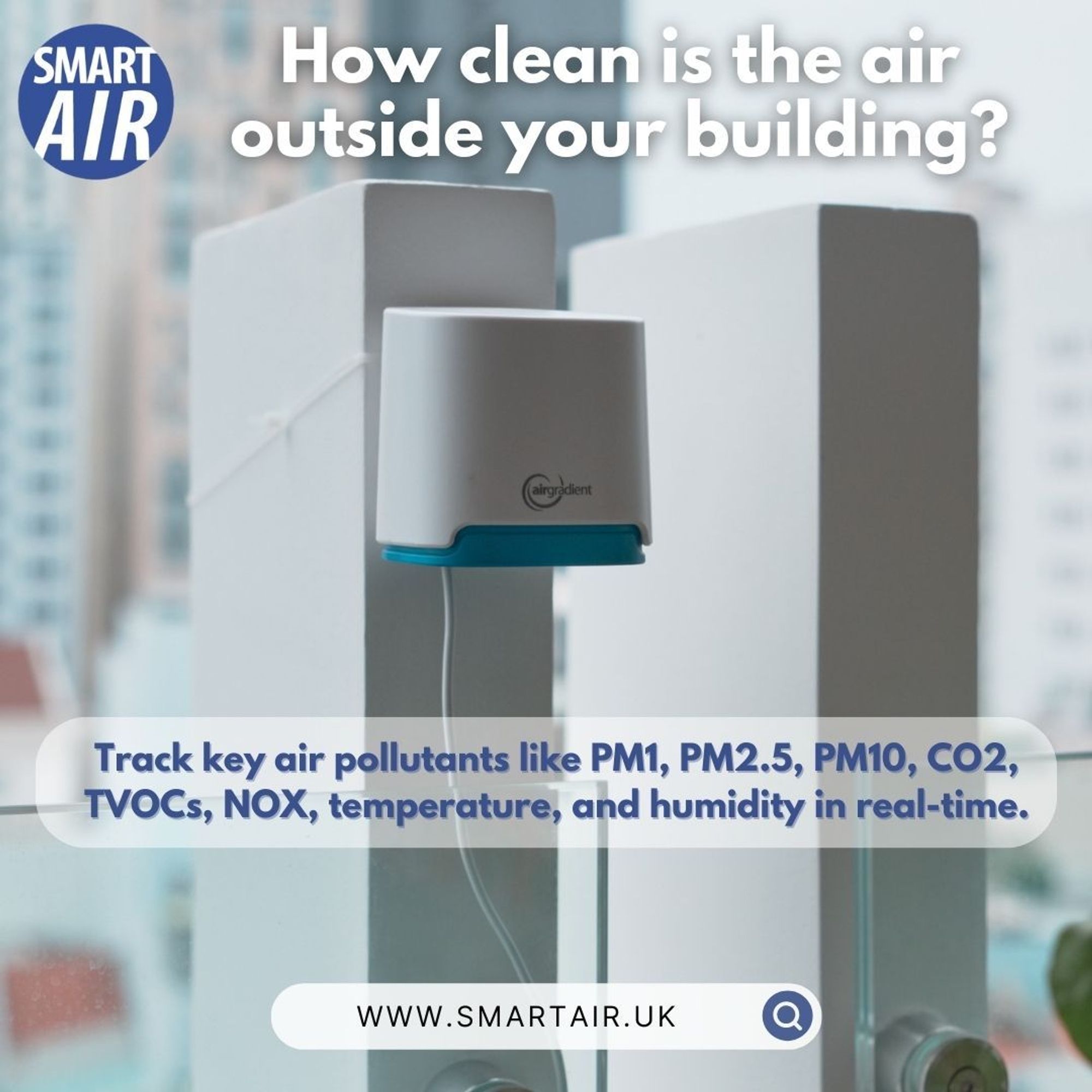 An outdoor air quality monitor attached to a building pillar, set against an urban backdrop. Text: ‘Track real-time air pollutants like PM2.5, CO2, and humidity.’