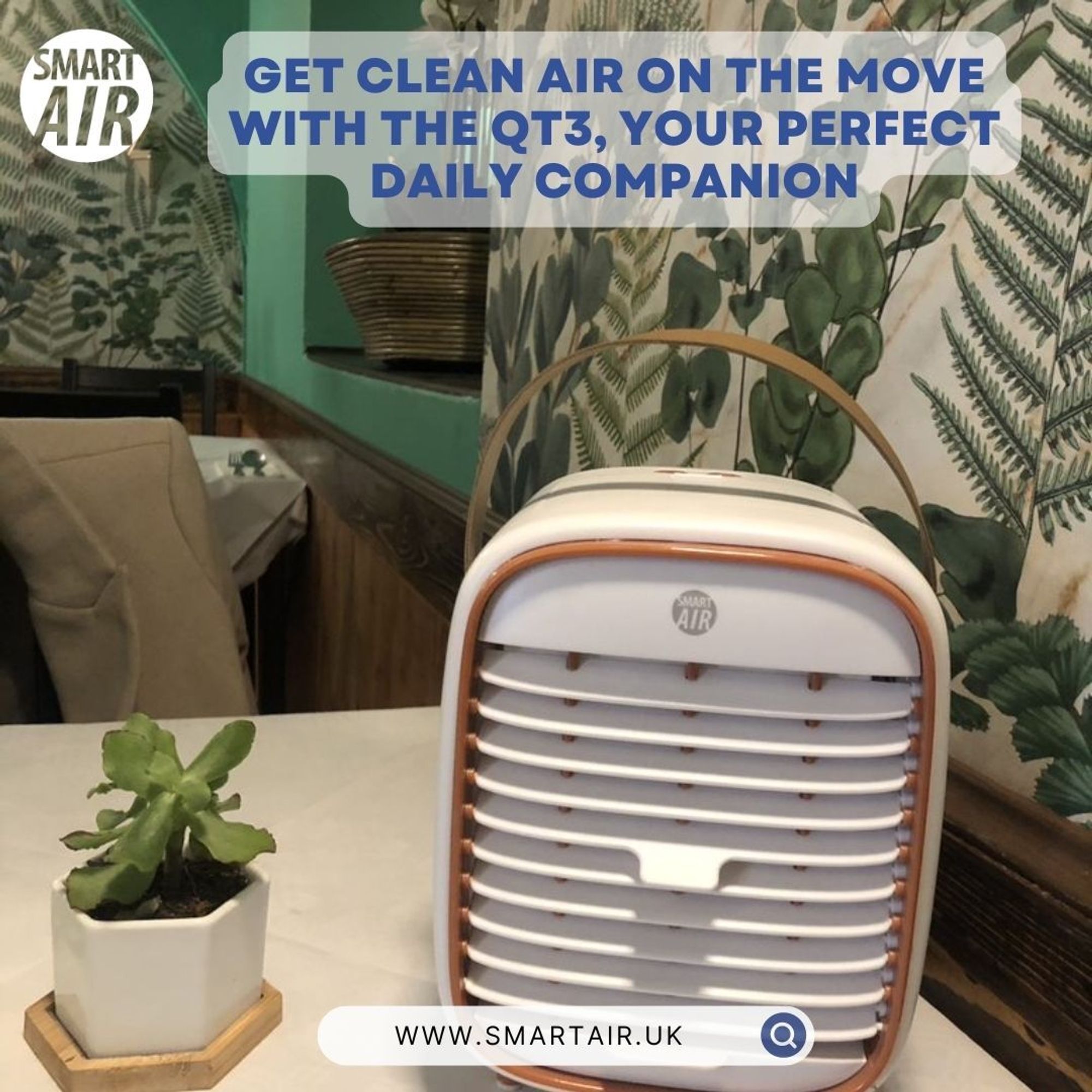 QT3 portable air purifier by Smart Air on a restaurant table with a potted plant next to it. The image is promoting the QT3 device by Smart Air, highlighting its functionality as a daily companion for clean air on the move.