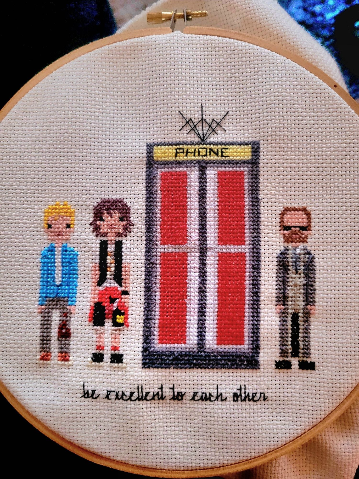 cross stitch of Bill & Ted & a phone booth & Rufus that says "be excellent to each other"