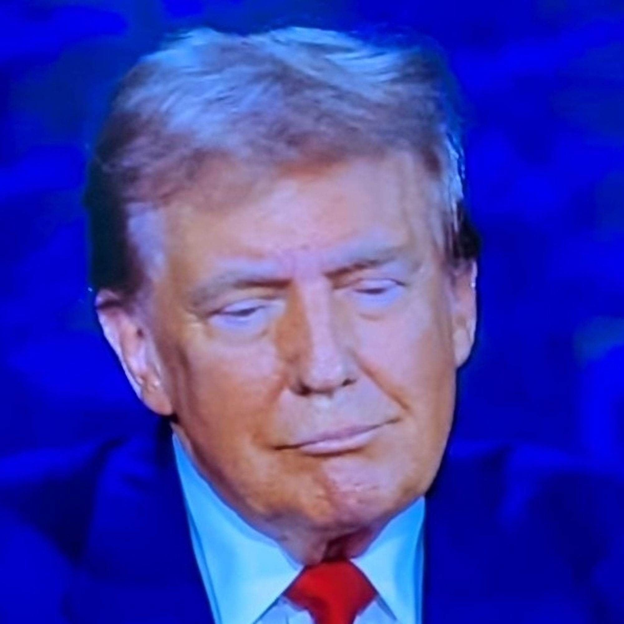 Donald Trump's face during tonight's debate. He has a smirk that hints at inner sadness.