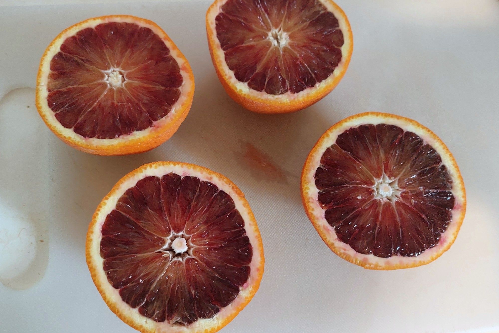 Oranges cut in half. The flesh is red instead of orange.