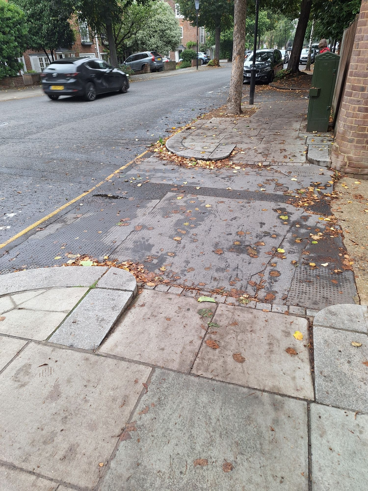 Flush vehicle drive access over footway with drop kerb either side lined by 300mm granite quadrants and kerbs