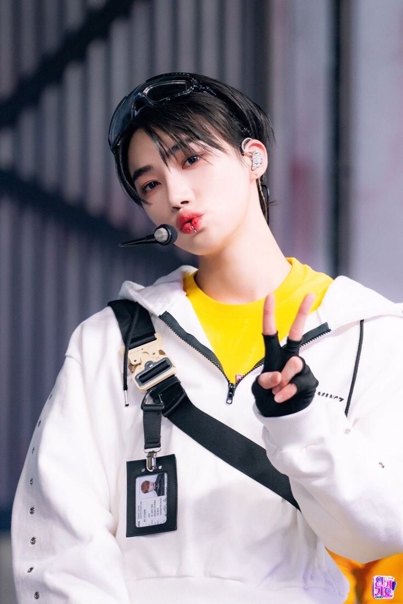 chanhee aka new, wearing a watch it era outfit, pouting and making a v-sign at the camera