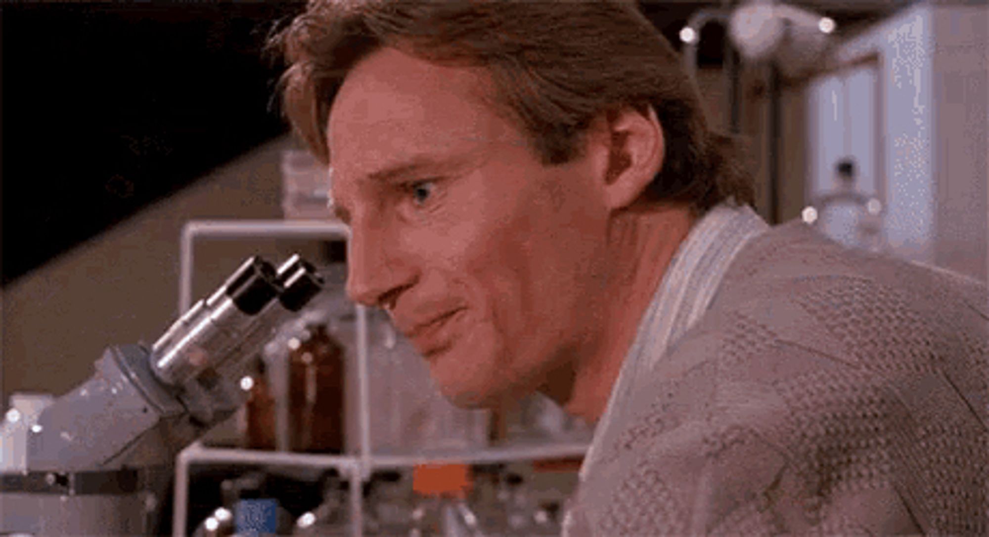 Scientist Peyton Westlake (Liam Neeson) turns from his microscope to ask "Why?"