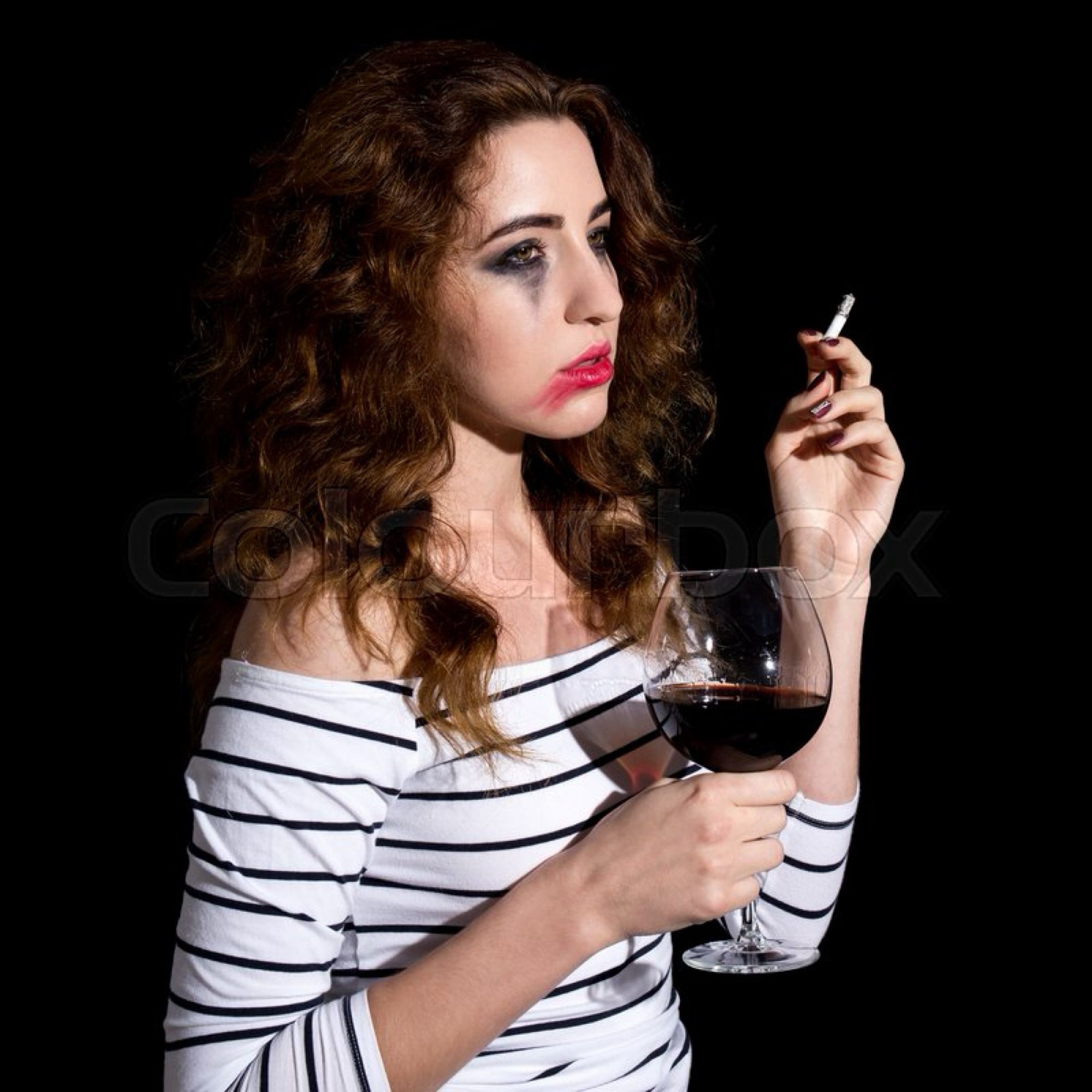 A woman with smeared makeup holding a big glass of wine and a cigarette