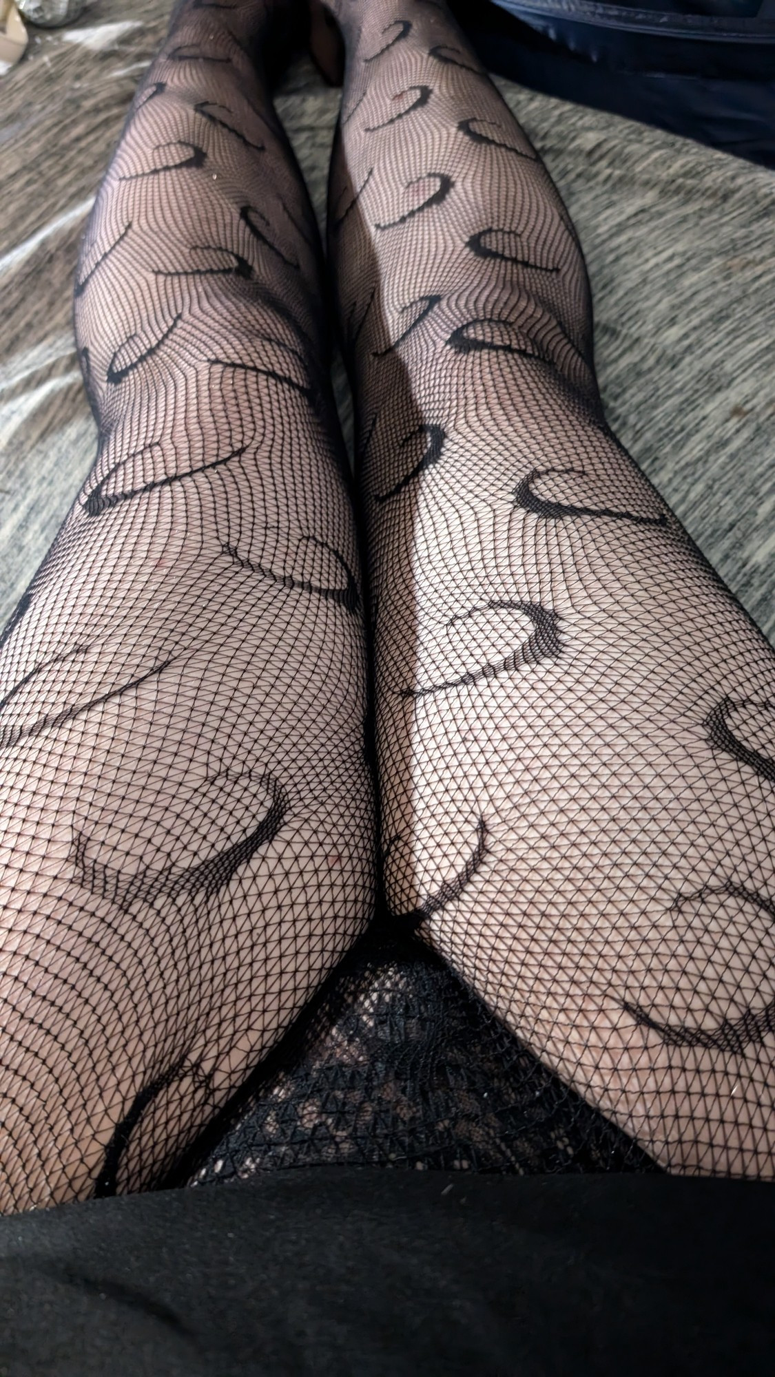 August showing her thighs while she is wearing black panties and fishnet tights with moons on them