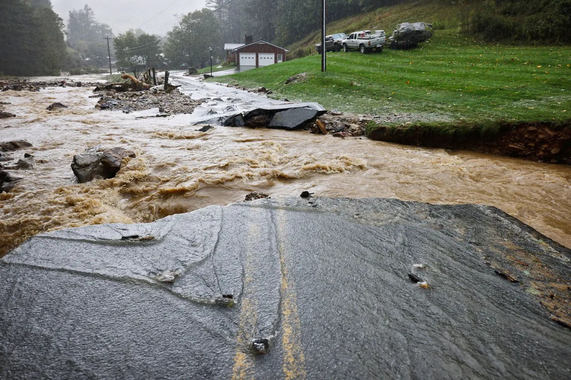 The Laurel Fork Road bridge sits destroyed from flood waters raging in the Upper Laurel Fork creek in Vilas, N.C., on Sept. 27.Jonathan Drake—Reuters