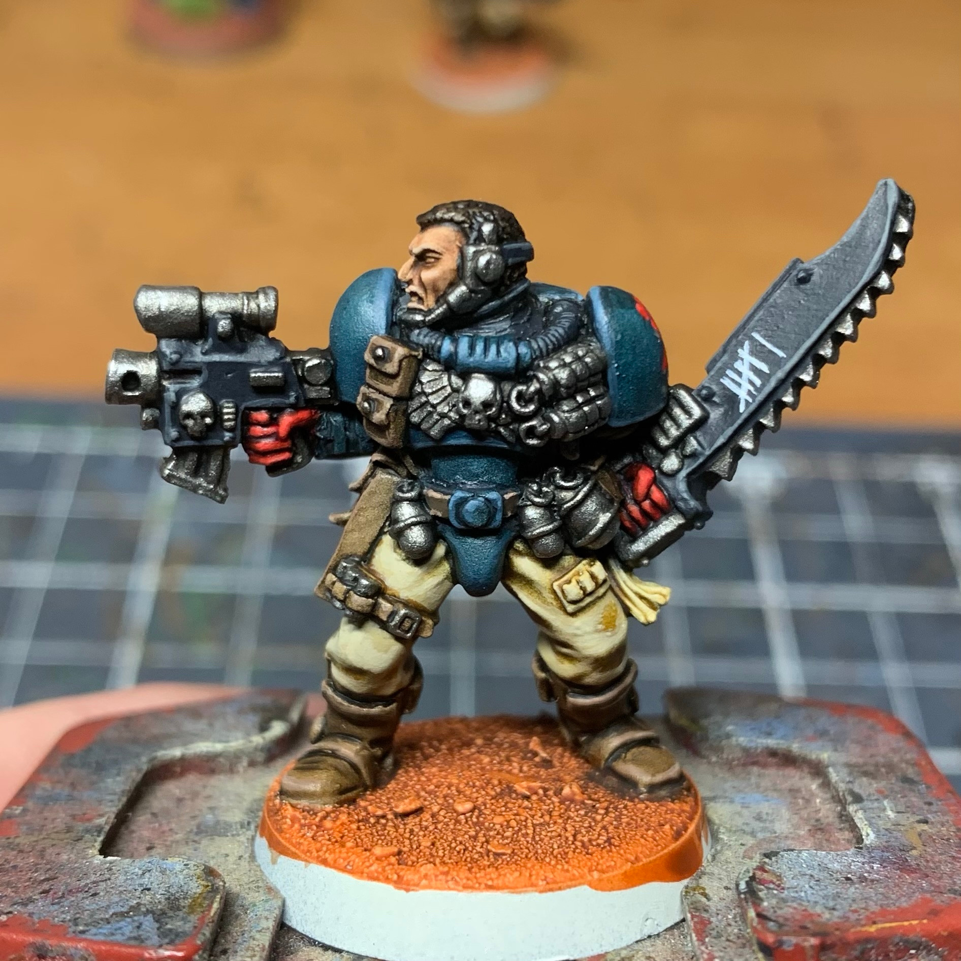 Space marine scout miniature, painted as a Crimson Fist. He has a tally on his chainsword, counted up to 6.