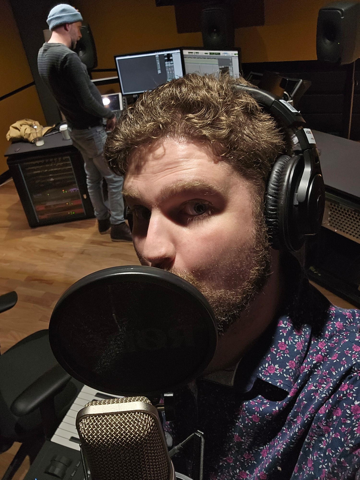 Laughy posing in recording studio with tech working in background