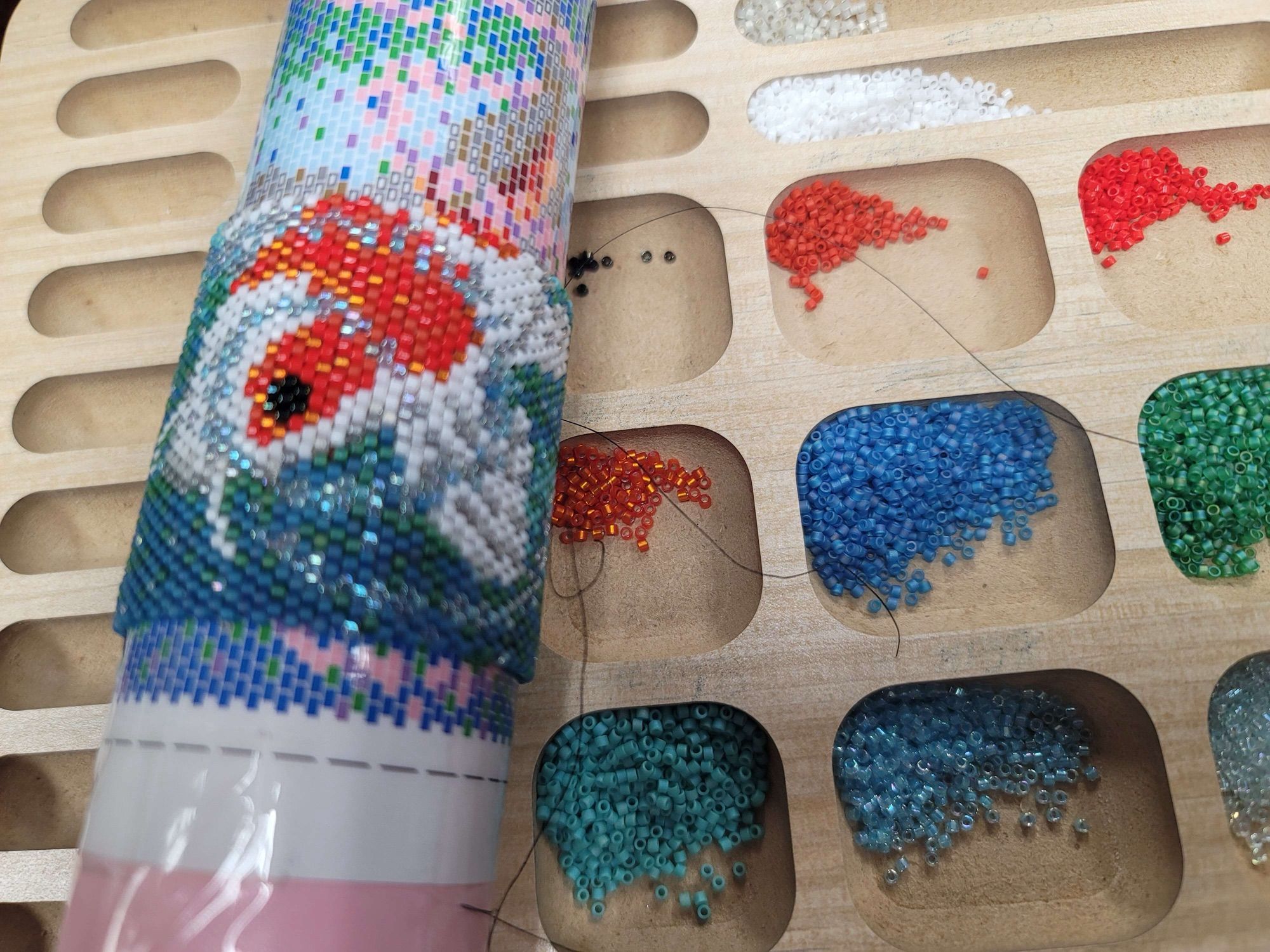 In-progress picture of a beaded painting of a Koi fish