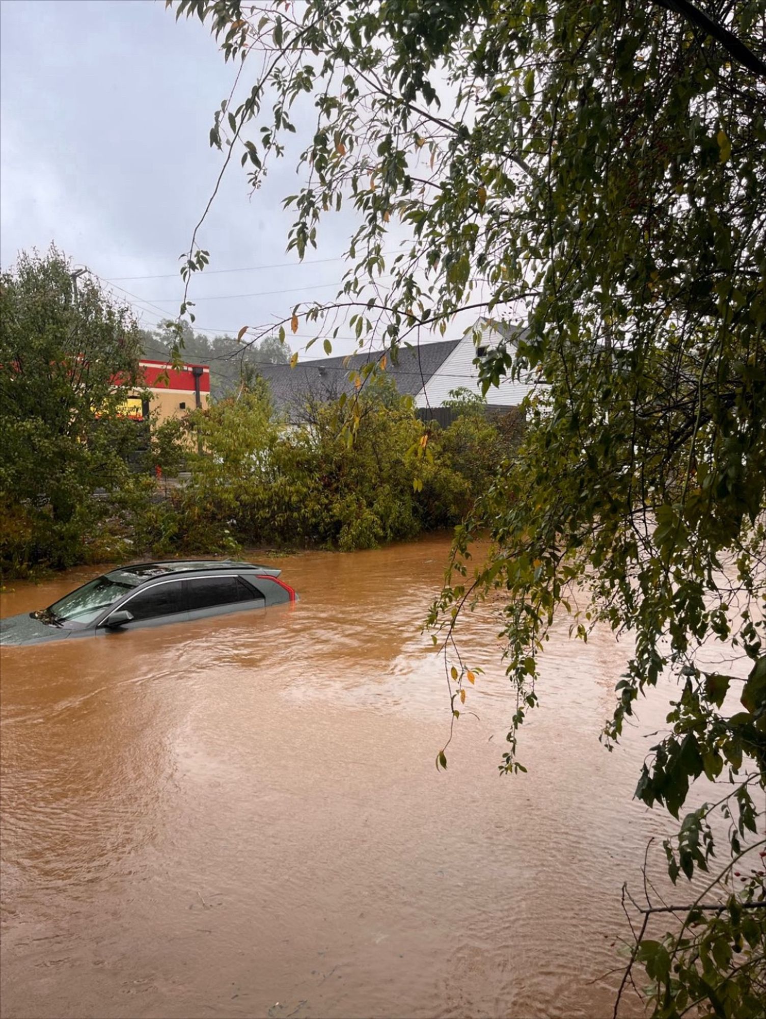 Car submerged under flood water.