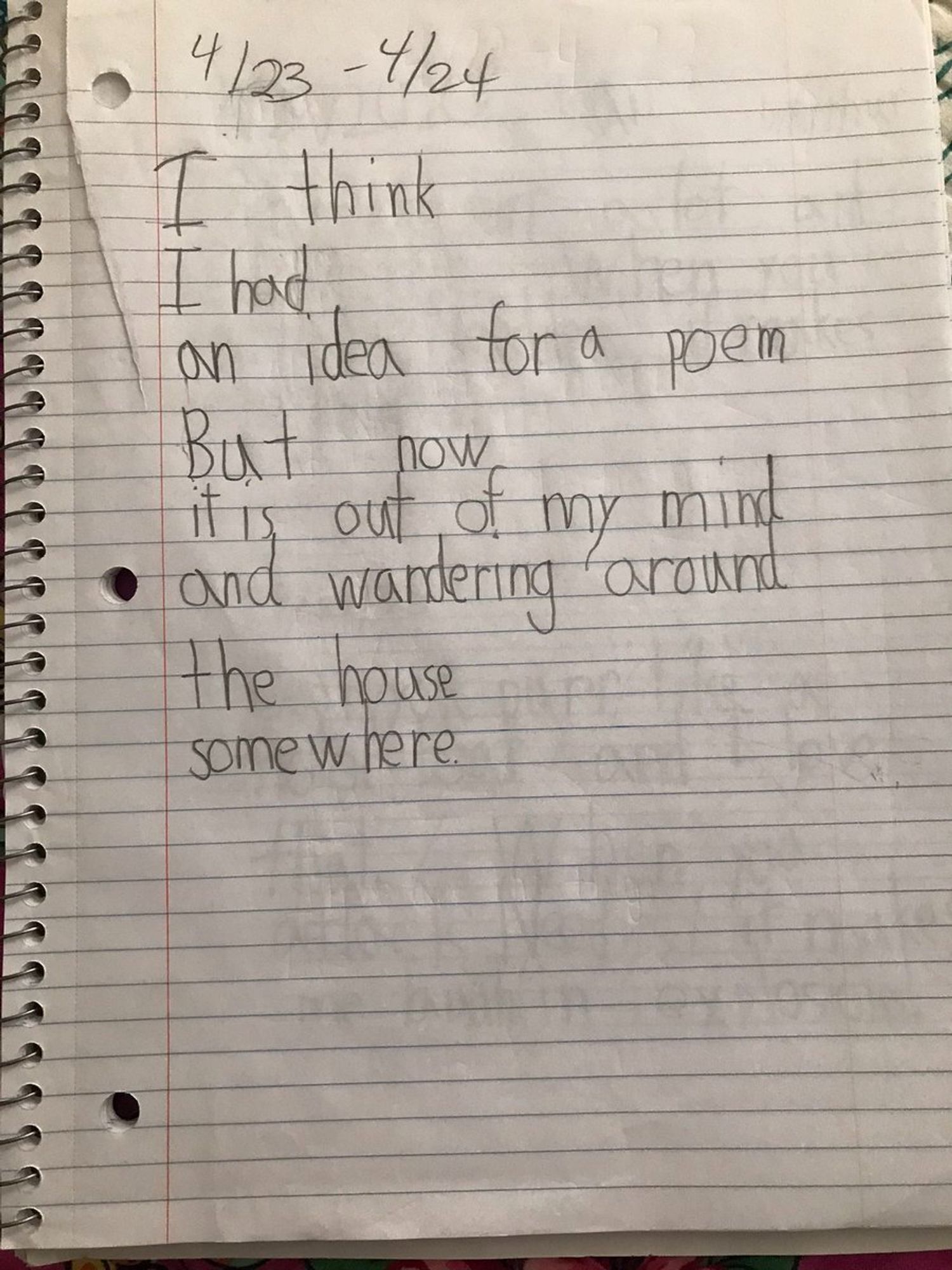 A page in a lined notebook has a poem written on in pencil reading:
I think
I had 
an idea for a poem
But now
it is out of my minnd
and wandering around
the house
somewhere