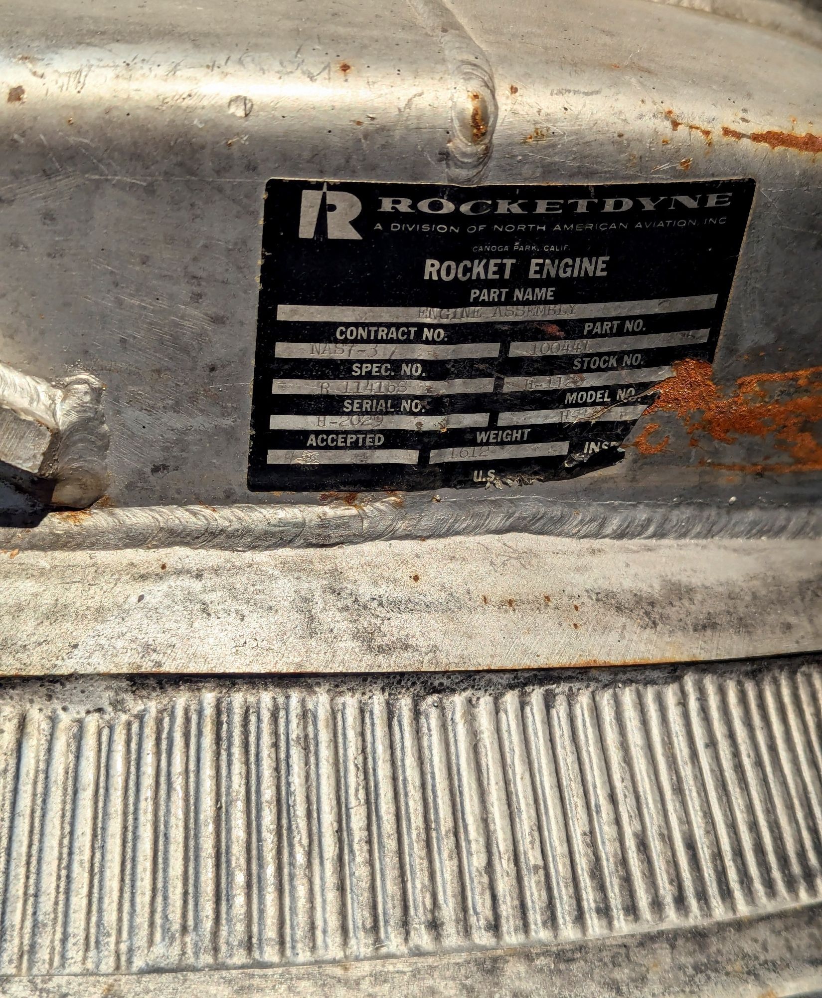 Black Rocketdyne label on the outside of a silver colored combustion chamber