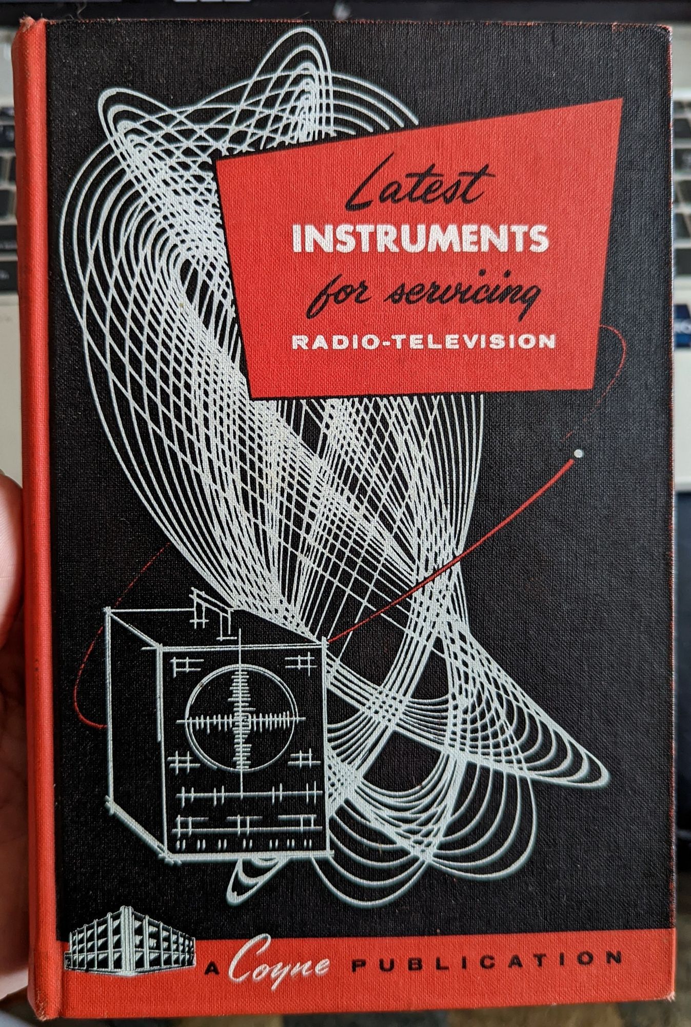 A black, red, and white hardcover book from 1957 titled "Latest Instruments for Servicing Radio-Television" with really striking cover illustration