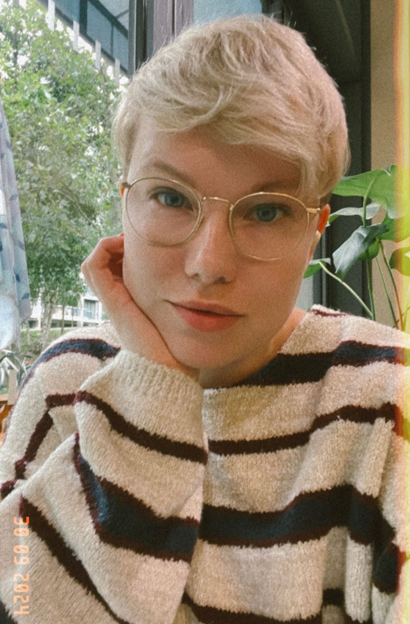 Selfie. I’m sat down and wearing a big stripy jumper and my glasses. Picture was taken on Instagram using a filter that adds grain to make it look like a Polaroid.