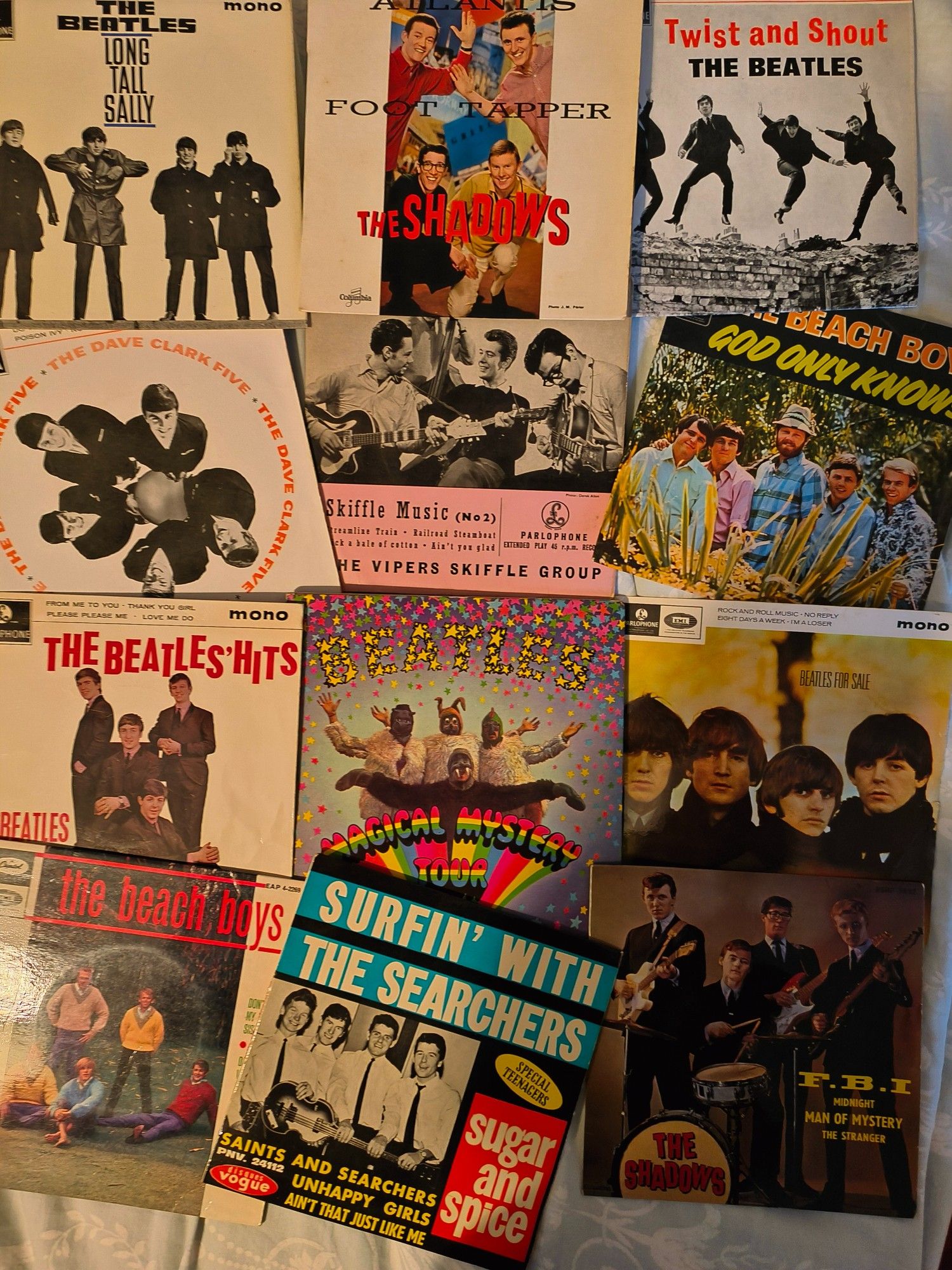 A photo of E.P. (Extended Play) 7 inch records. Records by The Beatles, The Shadows, The Searchers, The Dave Clark 5, The Beach Boys, The Vipers. The E.P. usually had 2 songs per side of a seven inch disc. Dearer than a single, cheaper than an L.P.