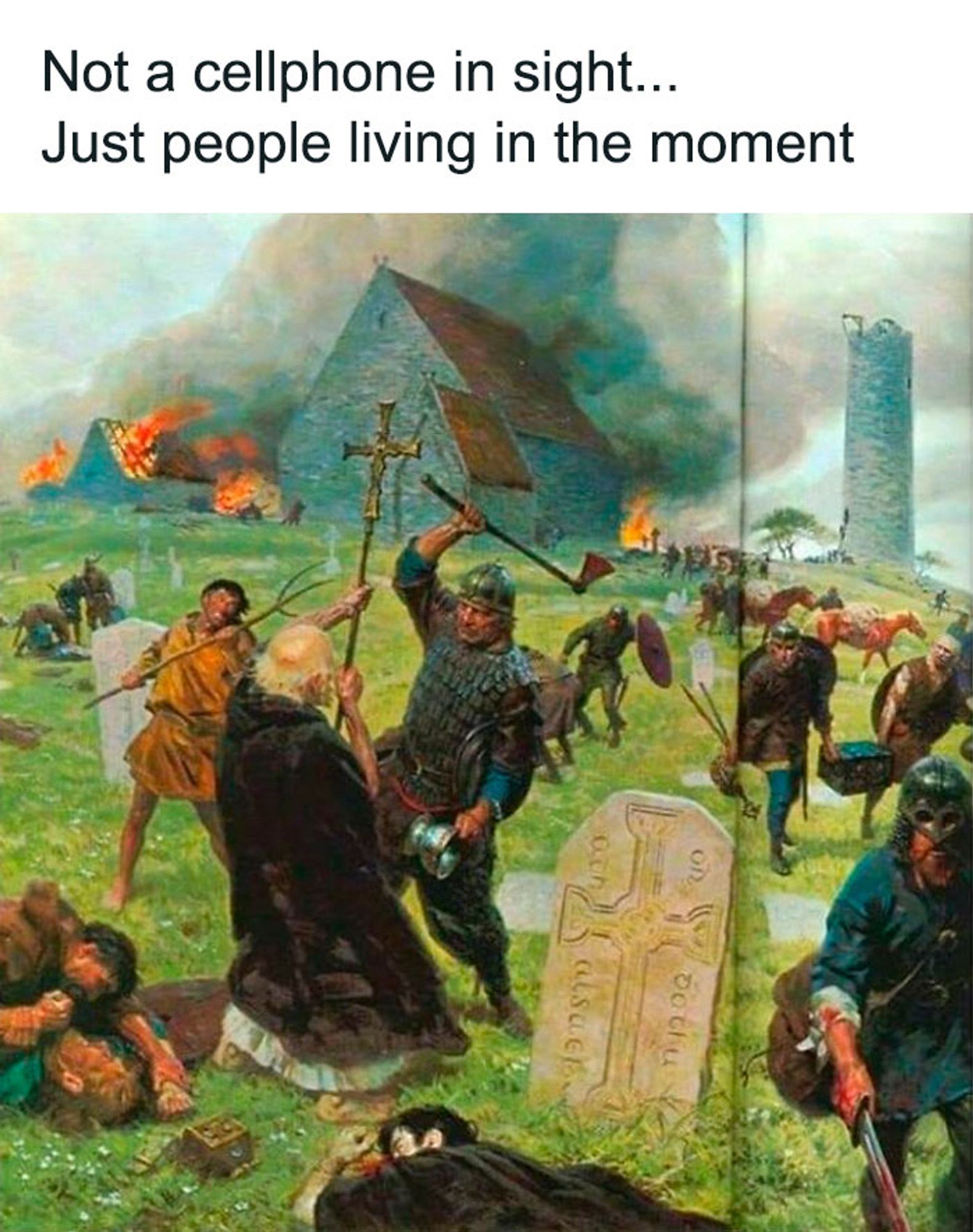 A picture of a village getting raided, burnt buildings in the background and people being killed, a priest is about to be axed down. It’s violent and chaotic. The text says not a cellphone in sight just people living in the moment