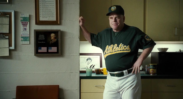 Philip Seymour Hoffman with his hands on his hip in Moneyball.