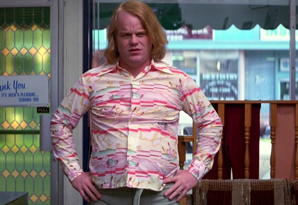 Philip Seymour Hoffman with his hands on his hip in Boogie Nights.