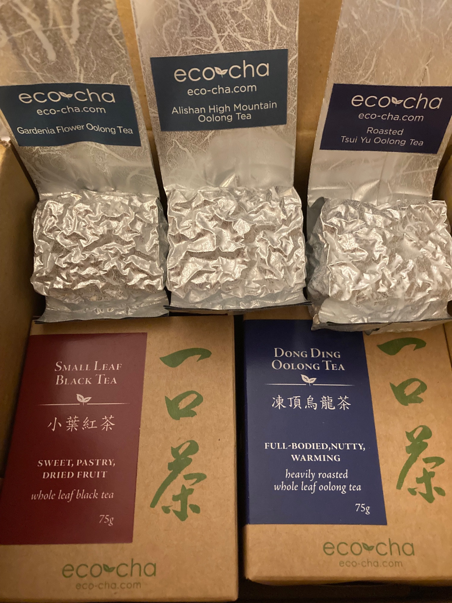 Boxes and bags of teas: gardenia oolong; alishan high mountain oolong; roasted tsui yu; small leaf black; and dong ding