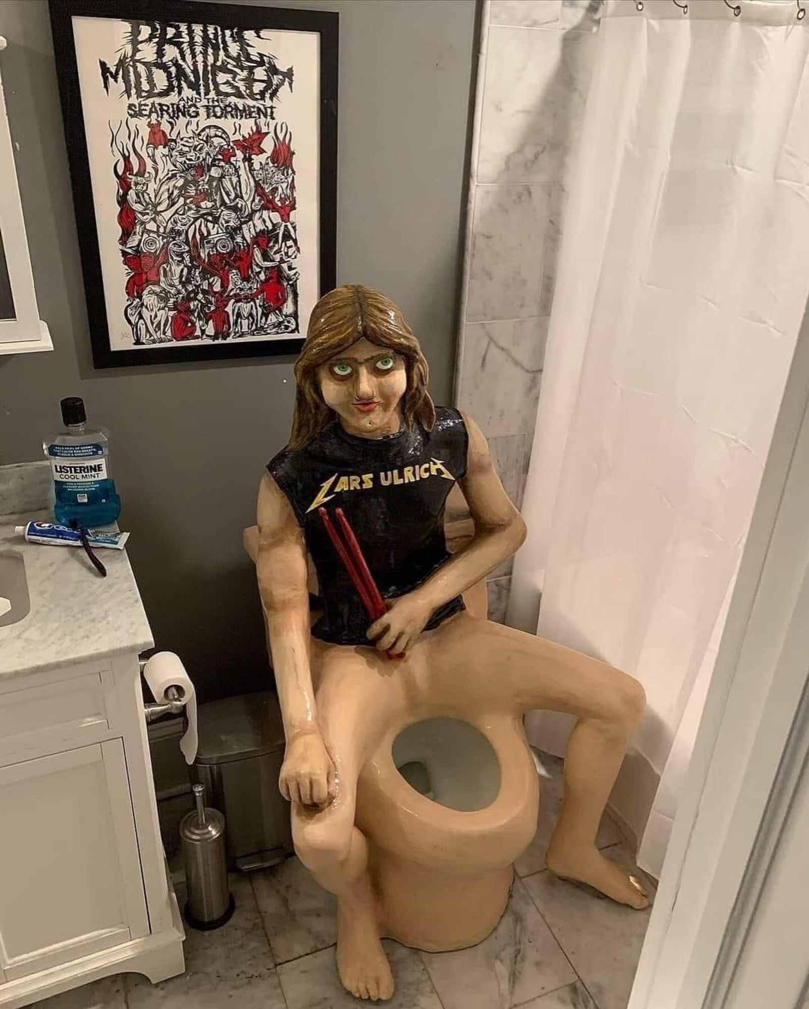 a toilet sculpted to resemble classic era Lars ulrich