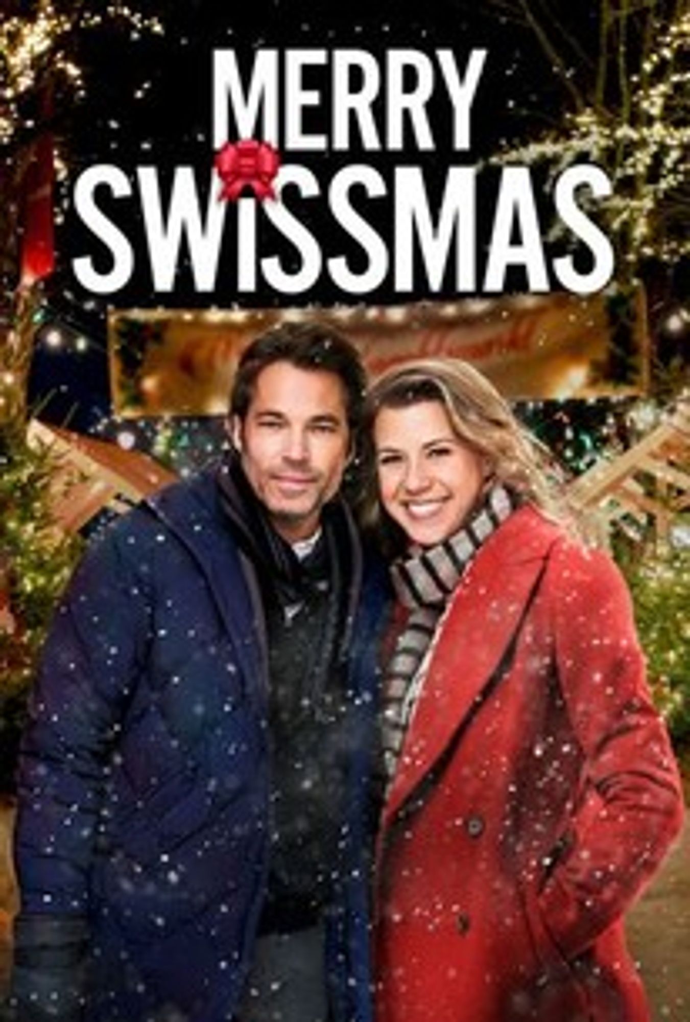 Promo image for Merry Swissmas - Mutt from Schitts Creek and Jodie Sweeten lean into each other while facing towards the viewer. Mutt has a dark blue winter coat on. Jodie has a red peacoat and black and white scarf on. They appear to be outside with snow falling around them and twinkling christmas lights behind them. Title across the top of the image.