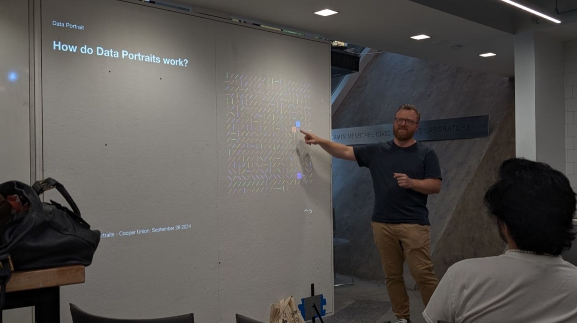 Gabriele from Accurat standing in front of a slide titled "how do data portraits work?'