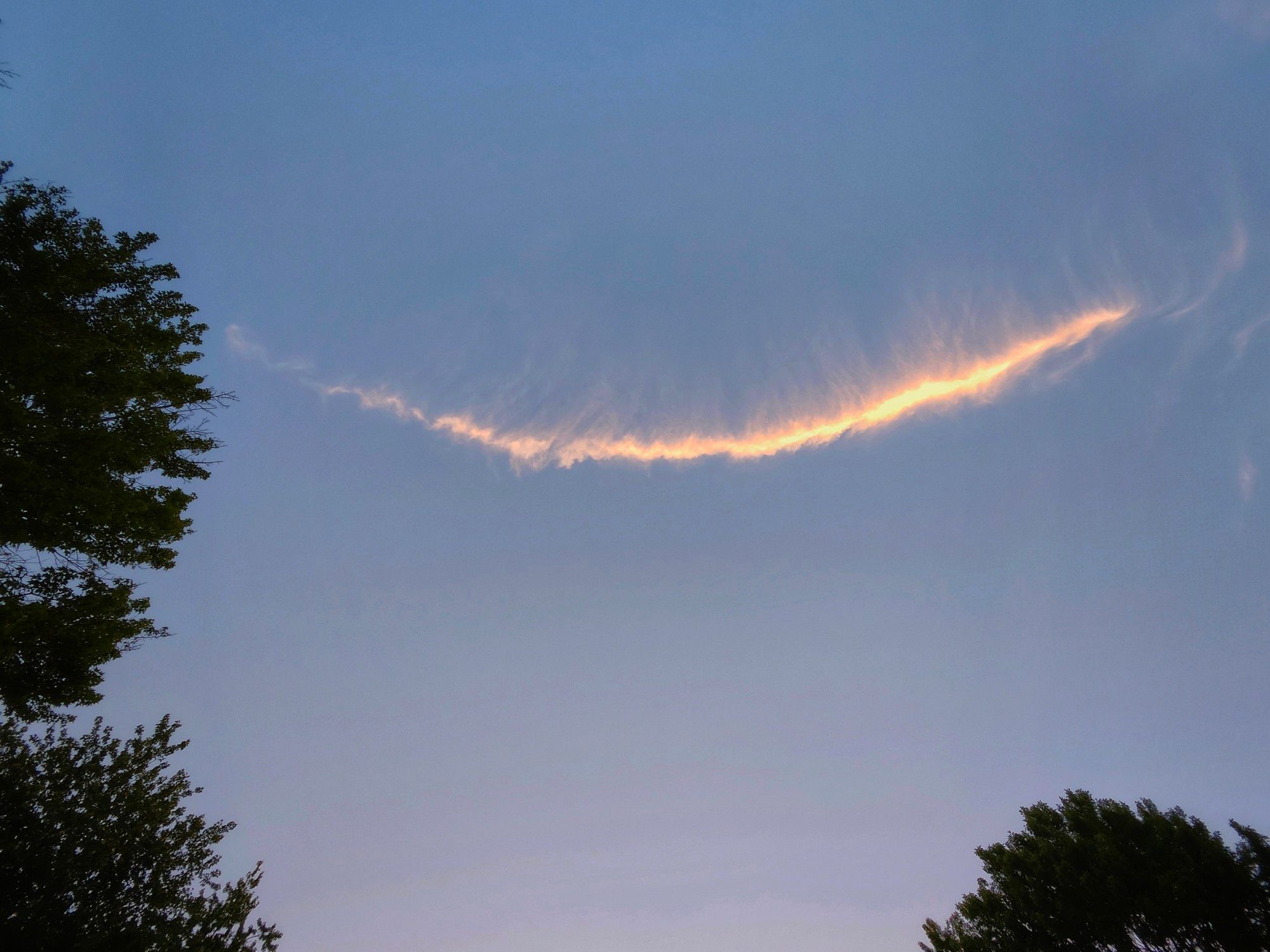 A thin wisp of cloud creates a smile on the sky.