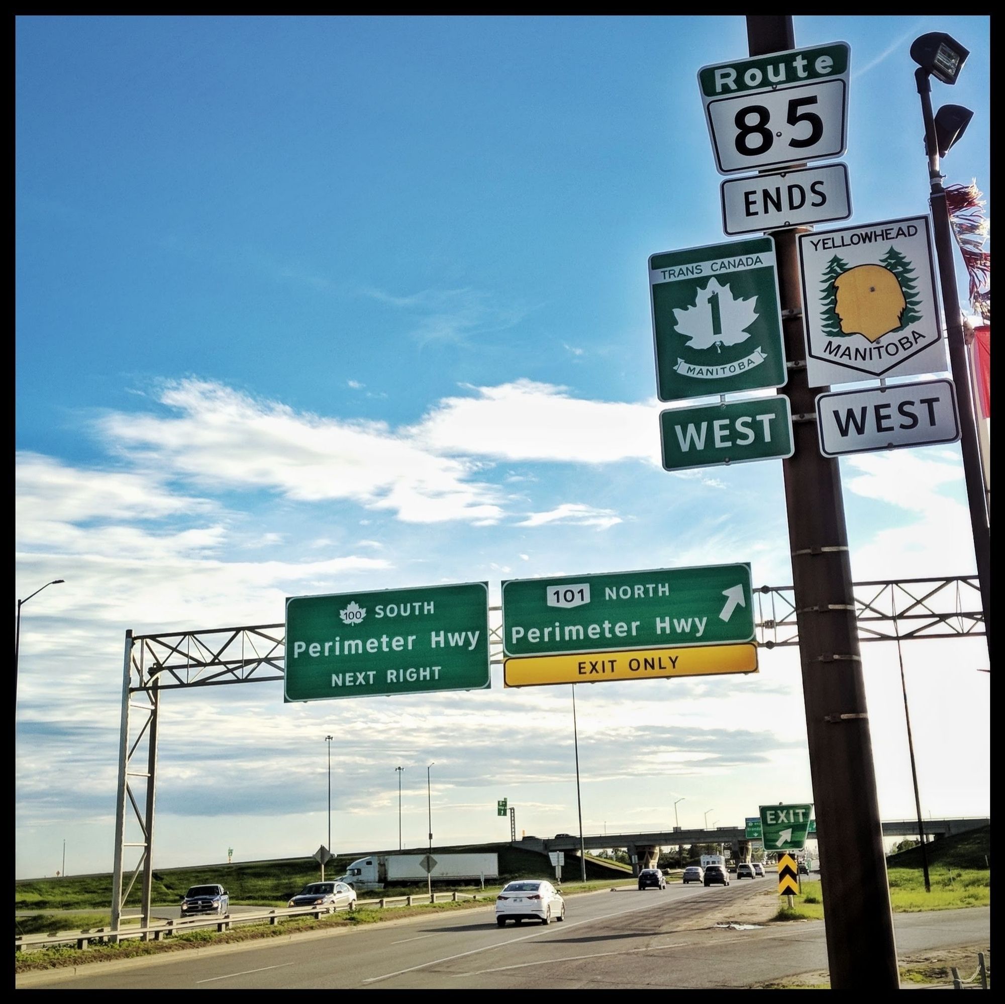 Road signs at Portage Avenue and the Perimeter Highway on the west side of Winnipeg Manitoba in June 2018