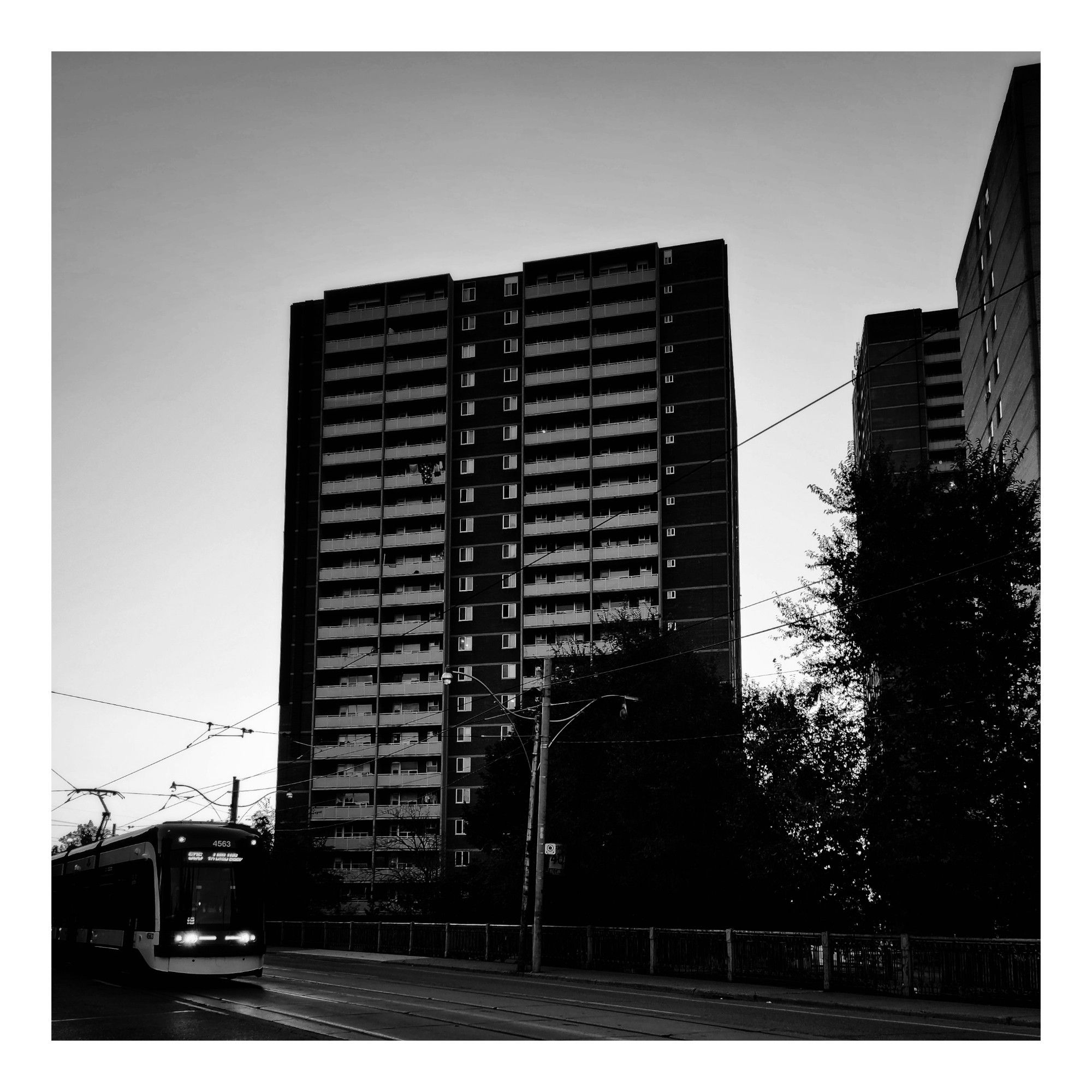 A Carlton streetcar passes a block of apartment buildings in the Regent Park neighbourhood of Toronto Ontario