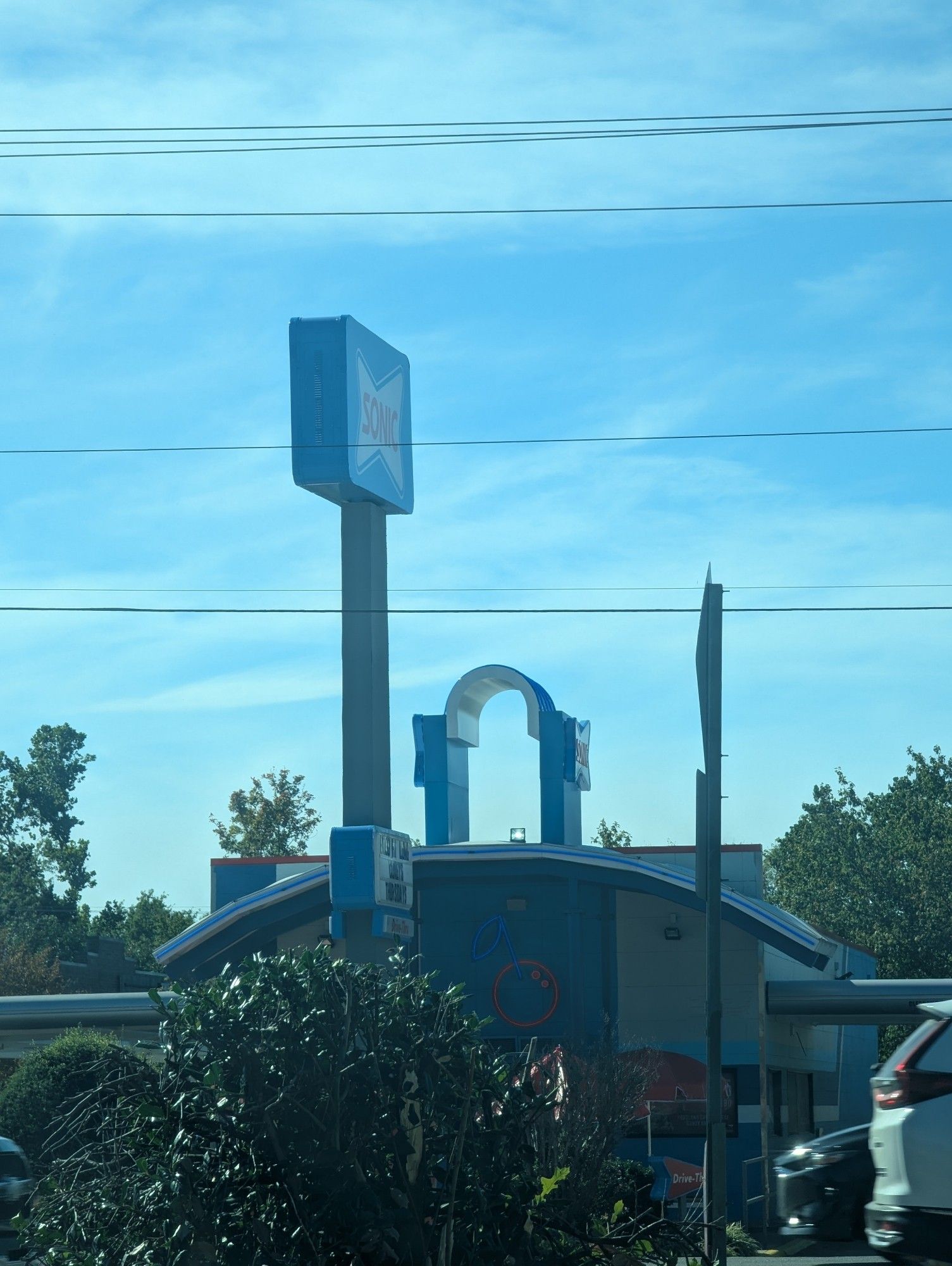 A sonic restaurant with an arch between their building roof signs