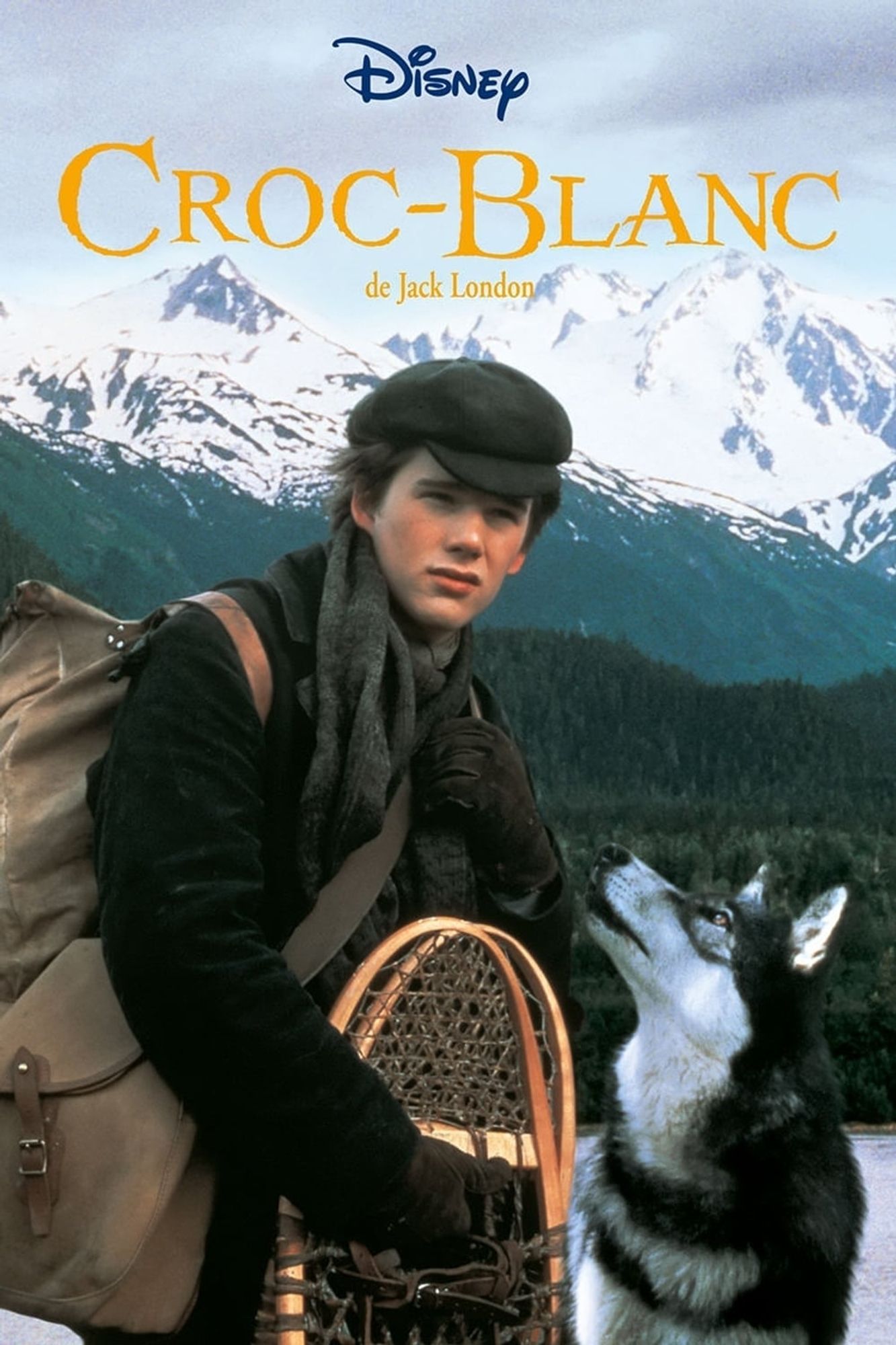 Affiche du film "Croc Blanc" (1991) de Randal Kleiser, adaptation du roman de Jack London.
Sur l'affiche : Ethan Hawke et un loup, sur fond de montagne.