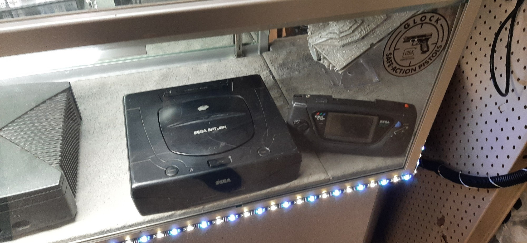 Sega Saturn and Game Gear at a pawn shop