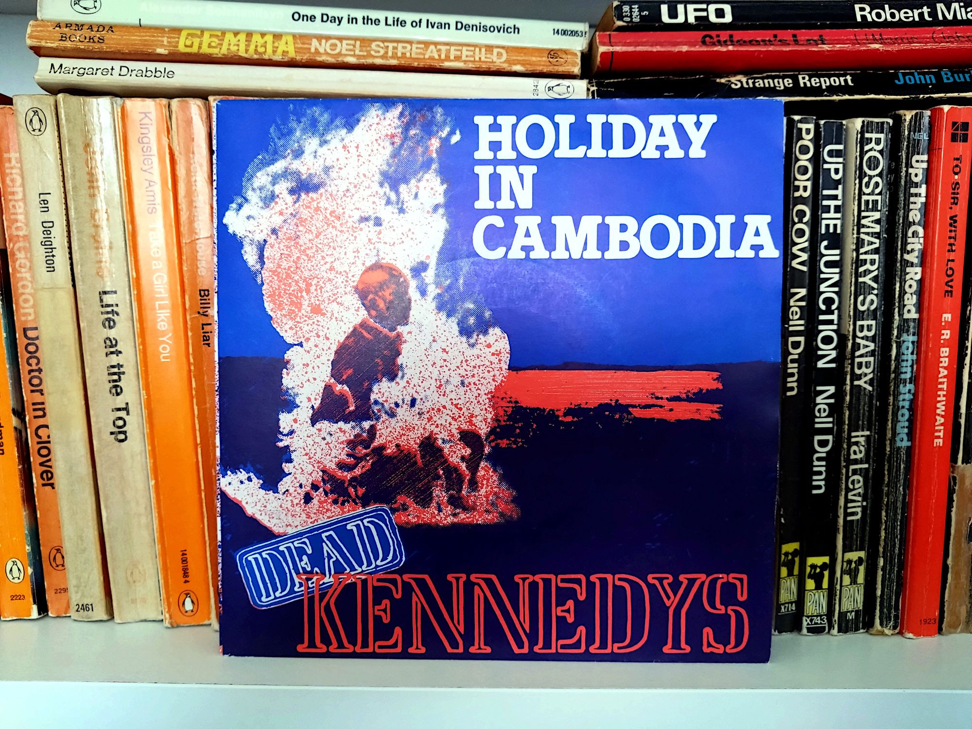 Picture of the Holiday In Cambodia single by Dead Kennedys in a picture sleeve showing a monk in flames