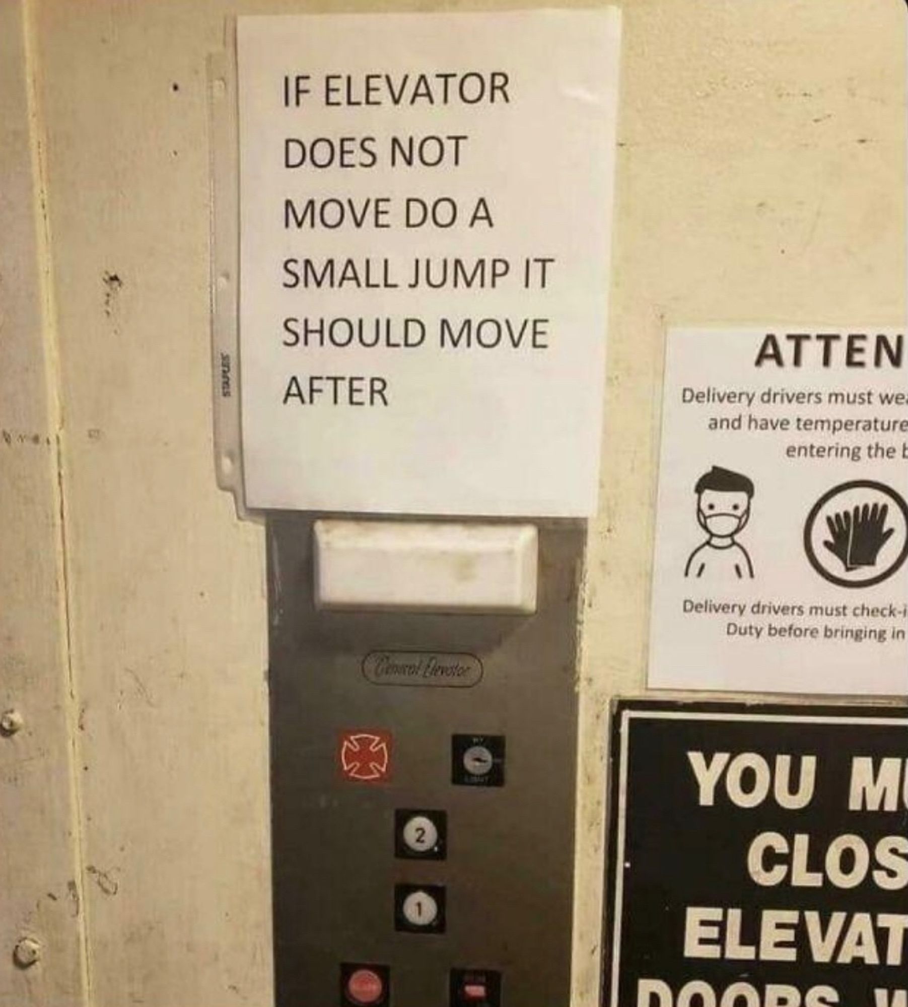 A sign in an elevator saying “If the elevator does not move. Do a small jump and it should move after that.”