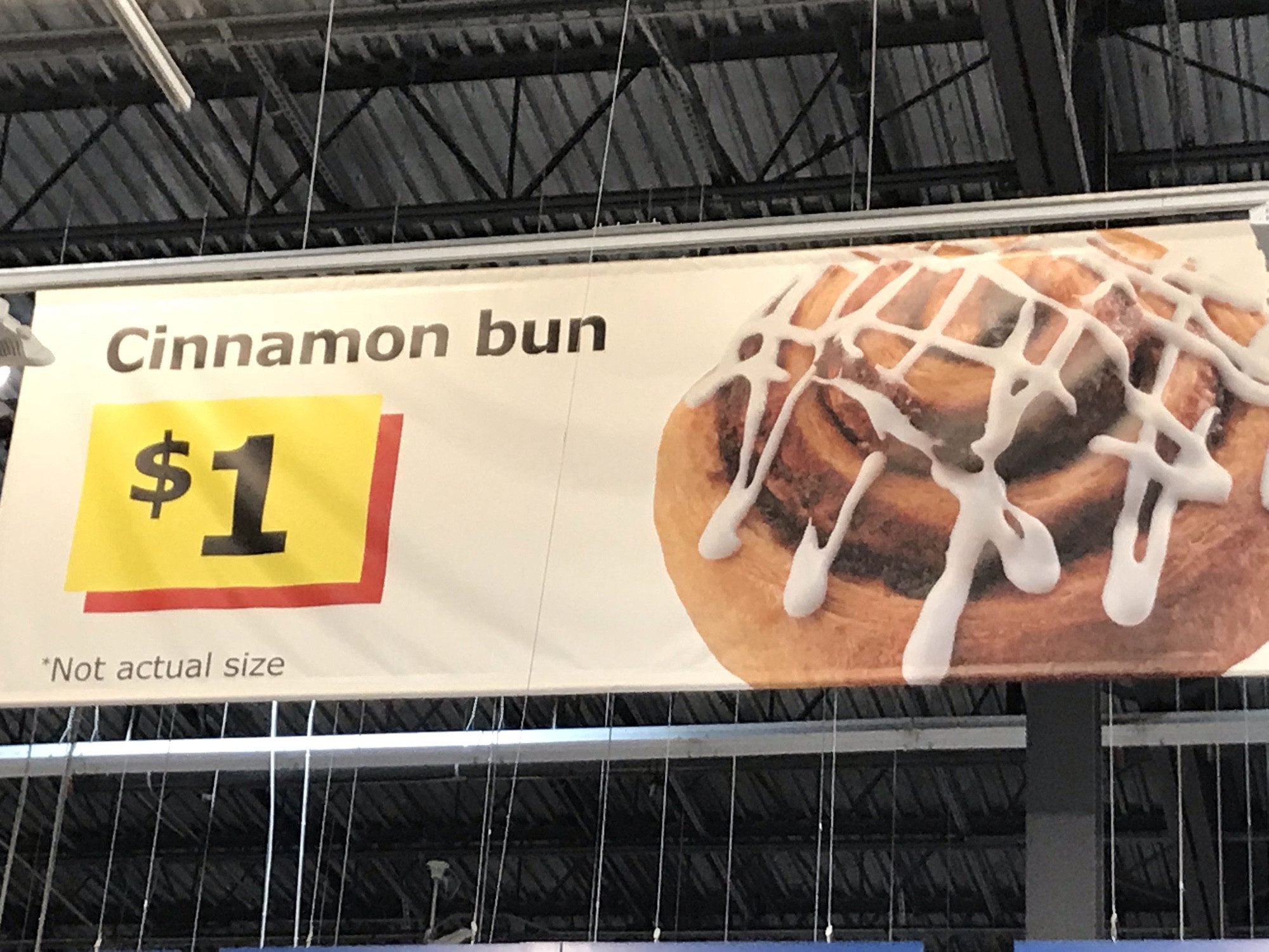 A banner advertising Cinnamon Bun for $1 at ikea. A small text at the bottom says “*Not actual size”