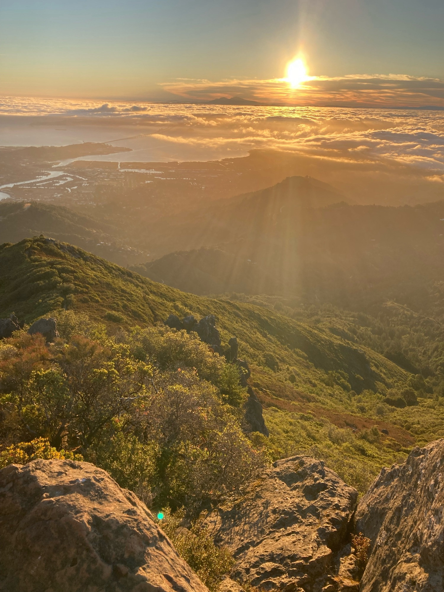 Sun, clouds, and hills from the mountaintop