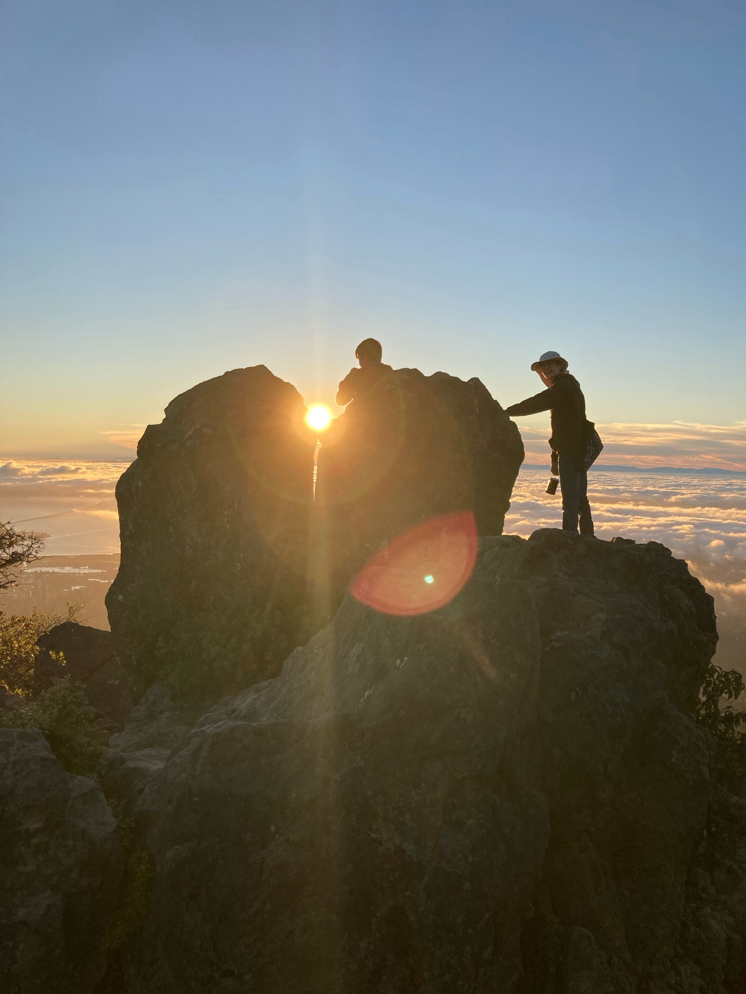 Hiking companions on a rock at the top of the mountain