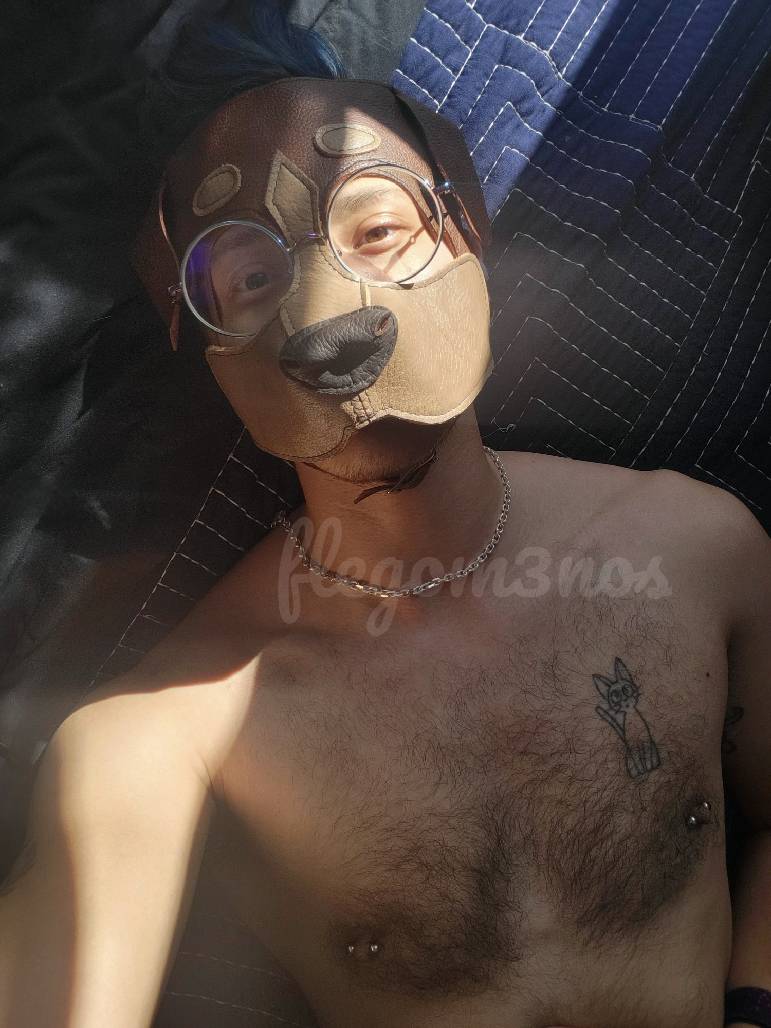 shirtless waist up portrait with a ray of sunshine across face and pup hood