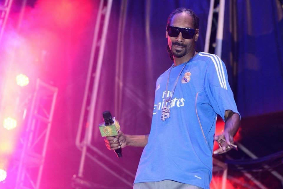 Snoop Dogg on stage wearing a Real Madrid CF shirt.