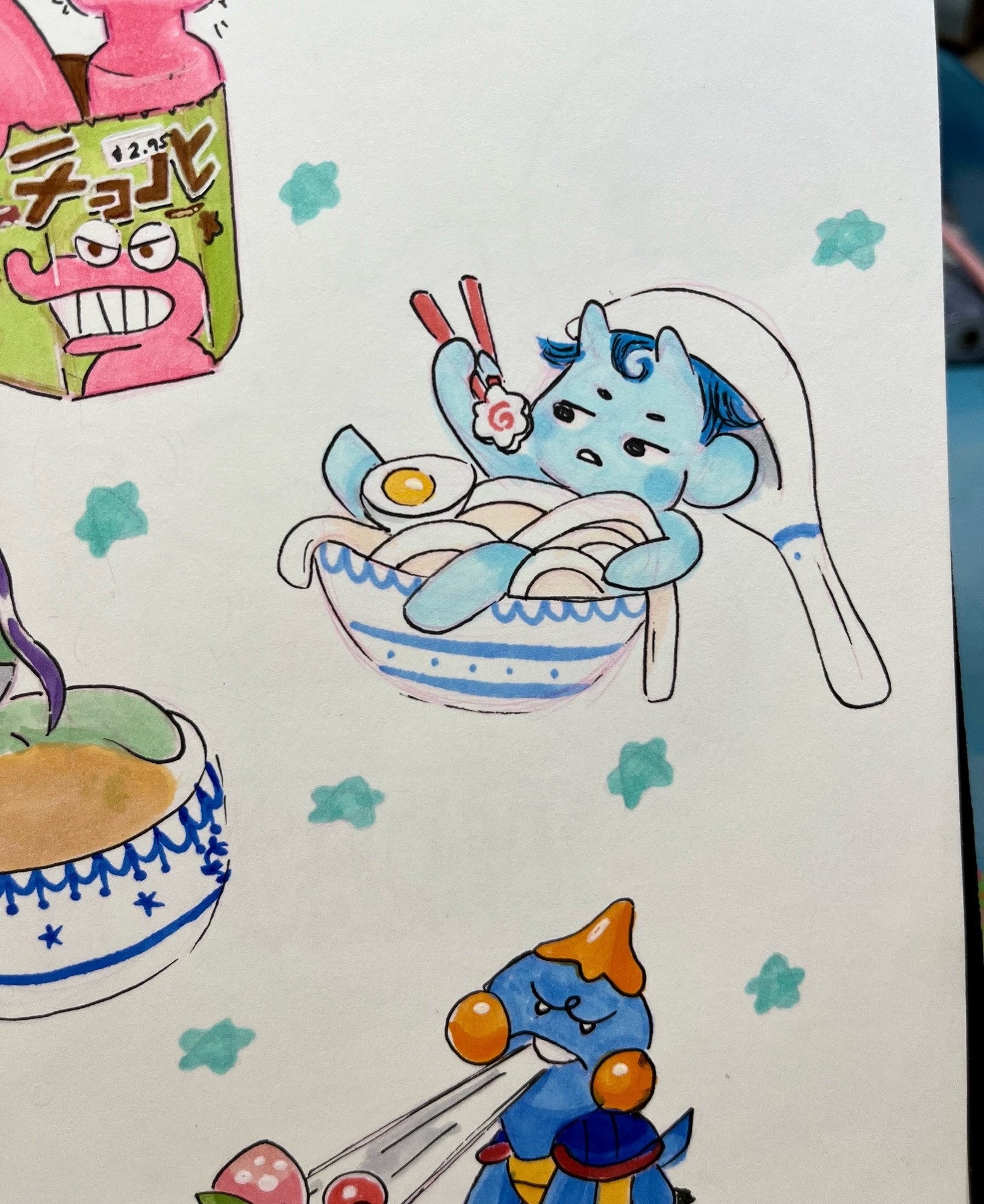 traditional art done with copic markers, a pen, and pink prisma pencil. there is a sky blue chibi gremlin with horns sitting in a ceramic bowl of noodles. thick udon noodles with an egg, and the gremlin is holding a narumaki with chopsticks and has a renge spoon hanging off their head. 