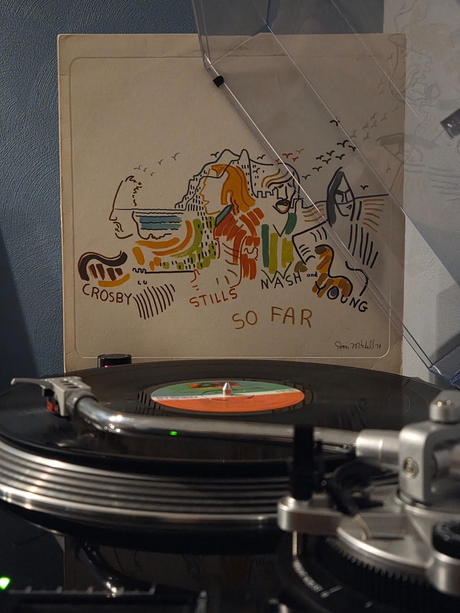Side view of a black AT-LP120 spinning So Far by Crosby, Stills, Nash and Young, its jacket propped up against the dust cover in the background 