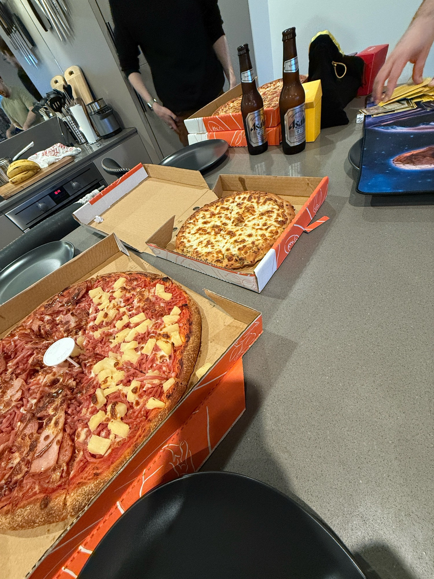 Meatlovers x Hawaiian pizza, garlic x cheese foccacia and beer on counter