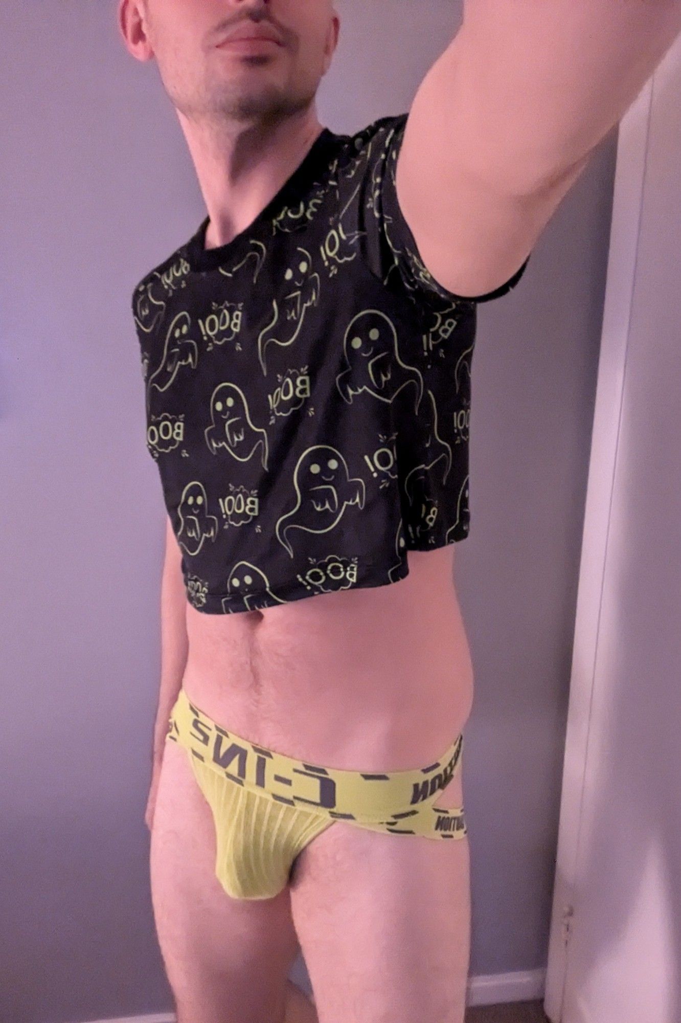 Yellow caution tape jockstrap and Boo! crop top.