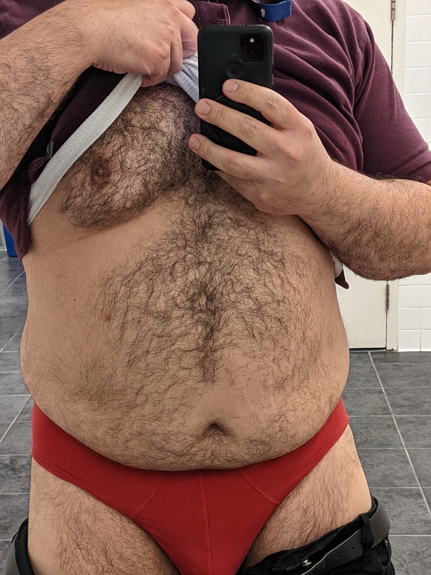 Selfie pic of moi pulling up a purple polo and undershirt to show off my red underwear and tummy.